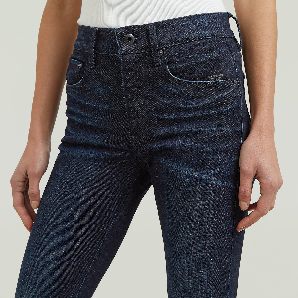 3301 flare jeans close-up showing medium rise, zip button closure, and G-STAR label details