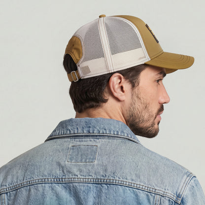 Baseball trucker cap with clip closure displayed on a man wearing a denim jacket.