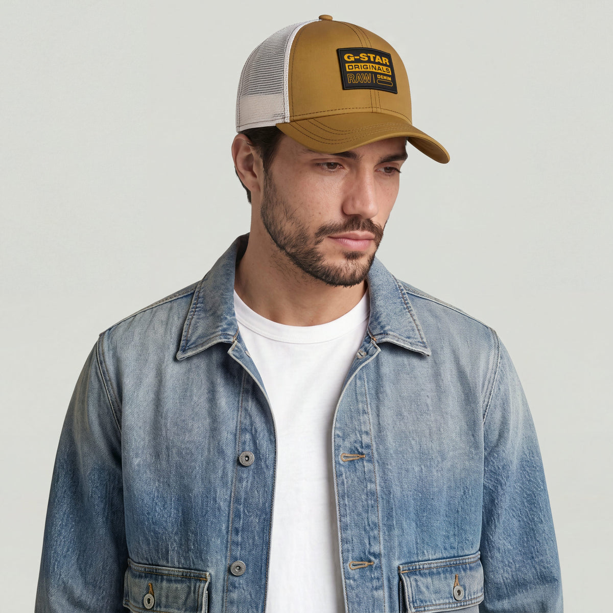Hombre usando una gorra baseball trucker cap with clip closure, resaltando el diseño clásico y la malla ventilada.