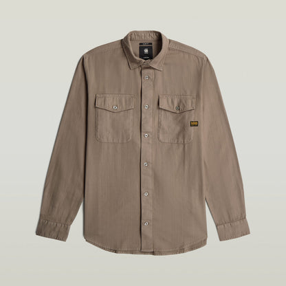 Marine slim fit shirt with rounded hem and flap pockets, styled for a modern look.