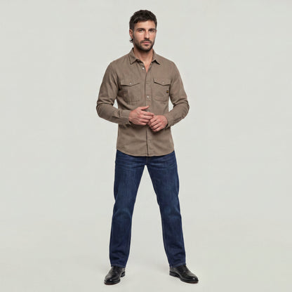Model wearing a marine slim fit shirt with slim cut and chest pockets.