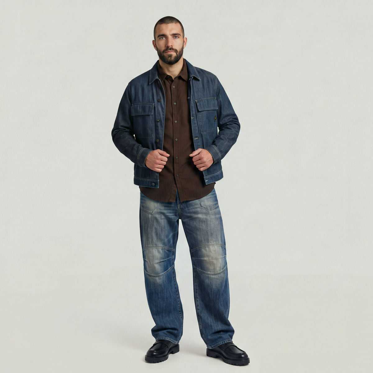 Model wearing a classic regular fit button-up shirt with denim jacket and jeans, showcasing a trendy outfit.