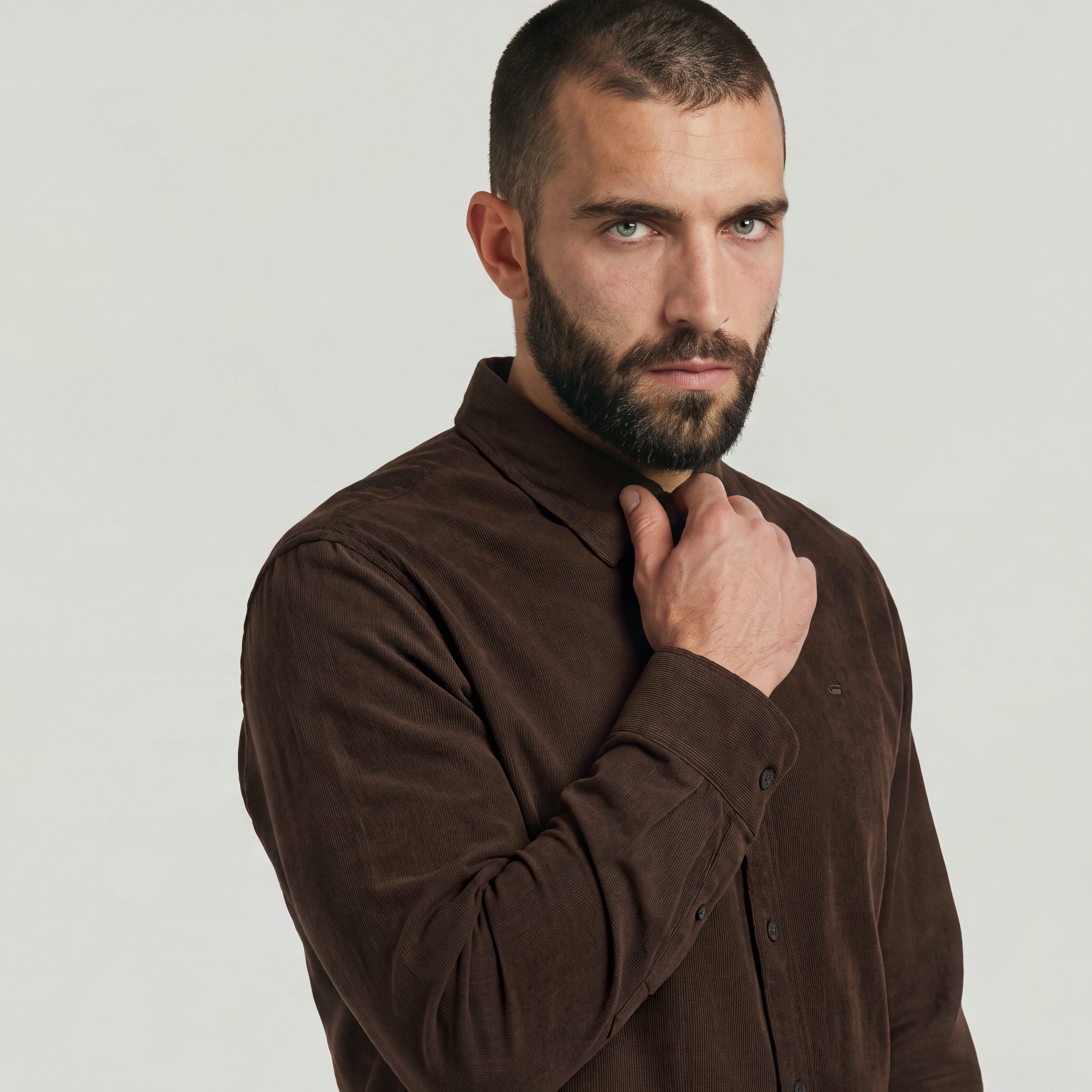 Model showcasing a classic regular fit button-up shirt in brown with button closure and collar.