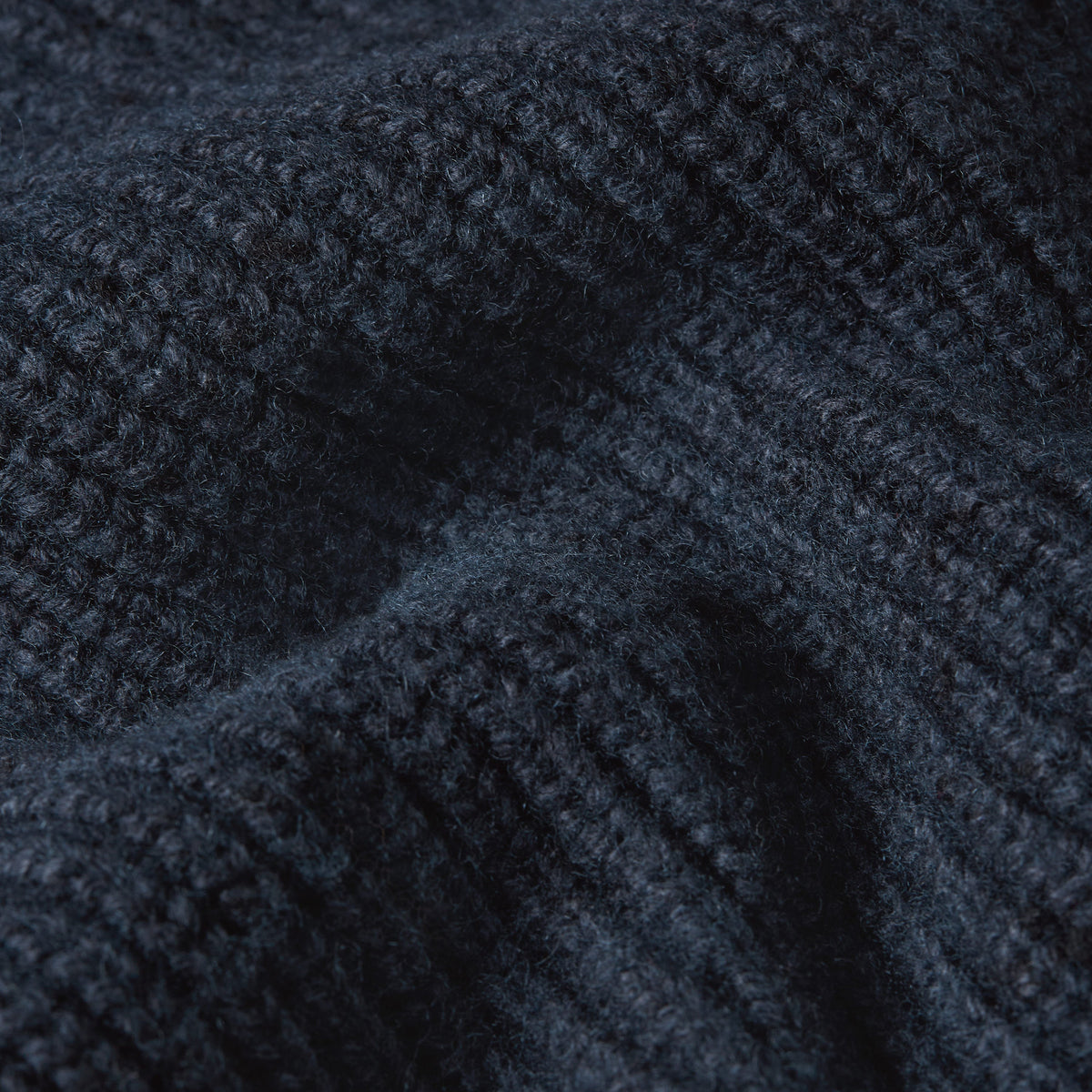 Close-up of fabric texture of a double collar half zip knit sweater in dark navy color.