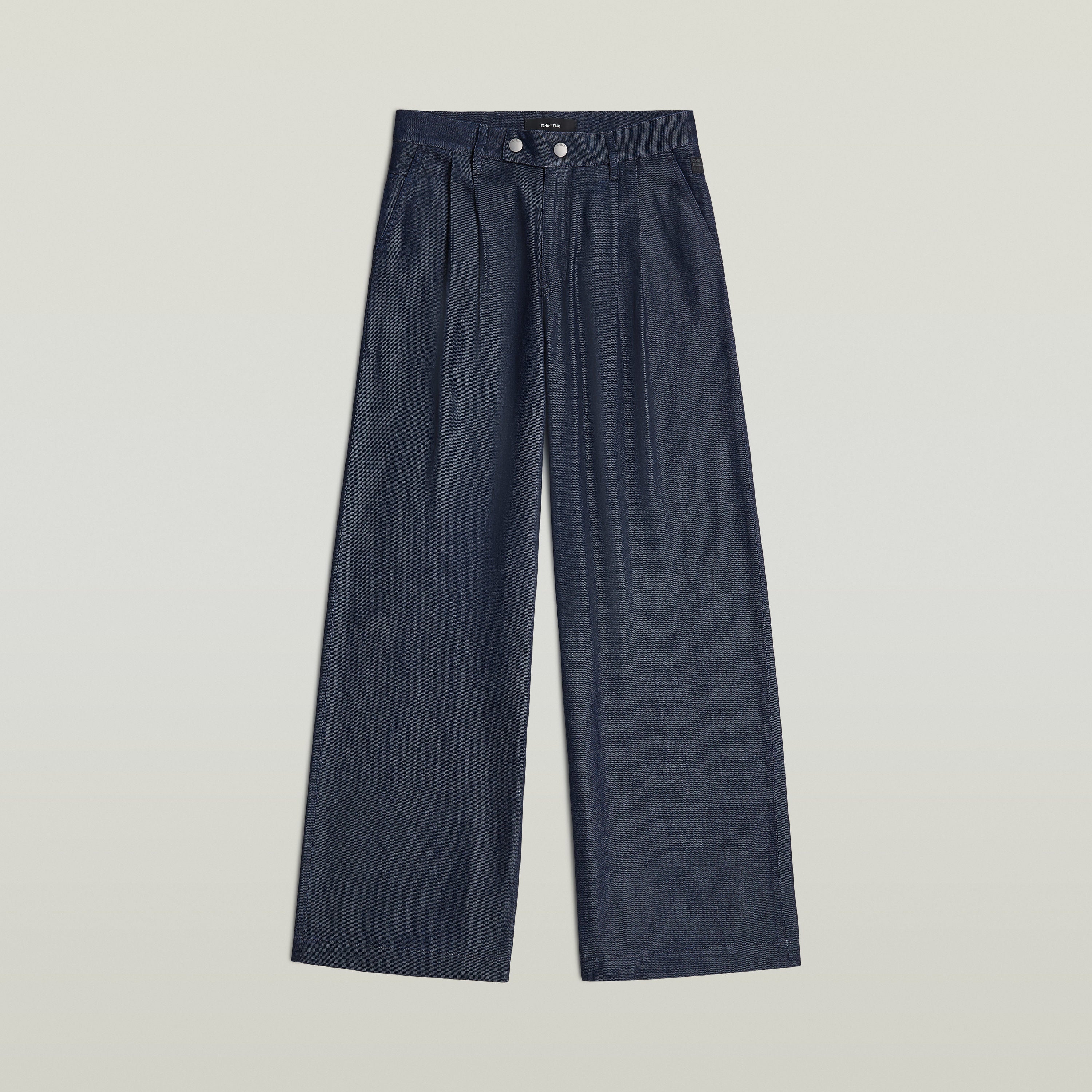 Pleated chino pants in dark denim with wide legs and a classic design, featuring a zipper closure and integrated pockets.