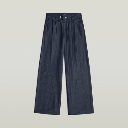 Pleated chino pants in dark denim with wide legs and a classic design, featuring a zipper closure and integrated pockets.