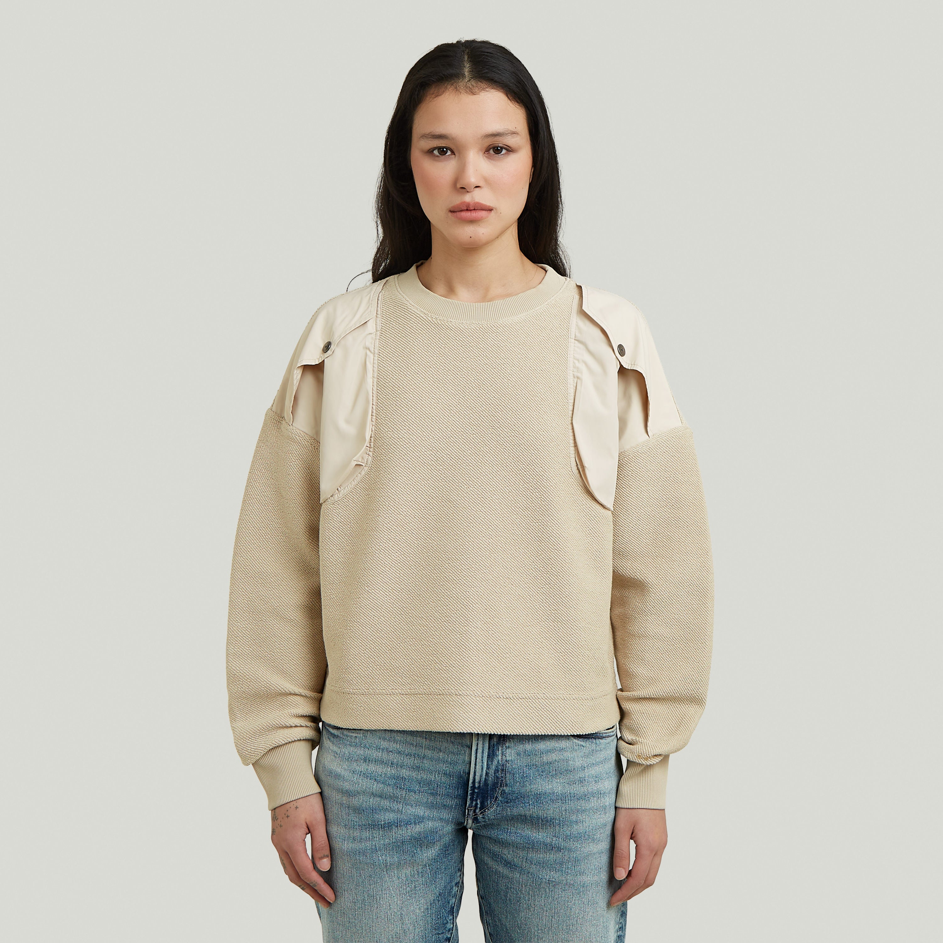 Loose fit mixed media sweater with round neck and long sleeves in beige color.