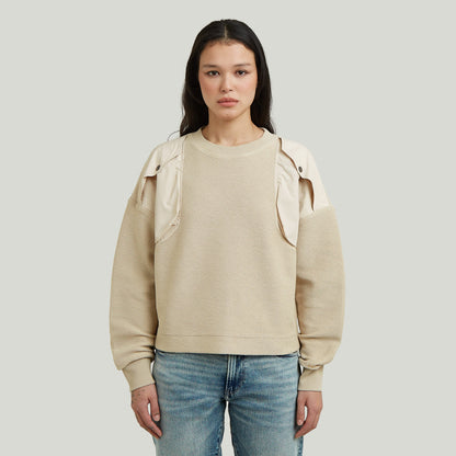 Loose fit mixed media sweater with round neck and long sleeves in beige color.