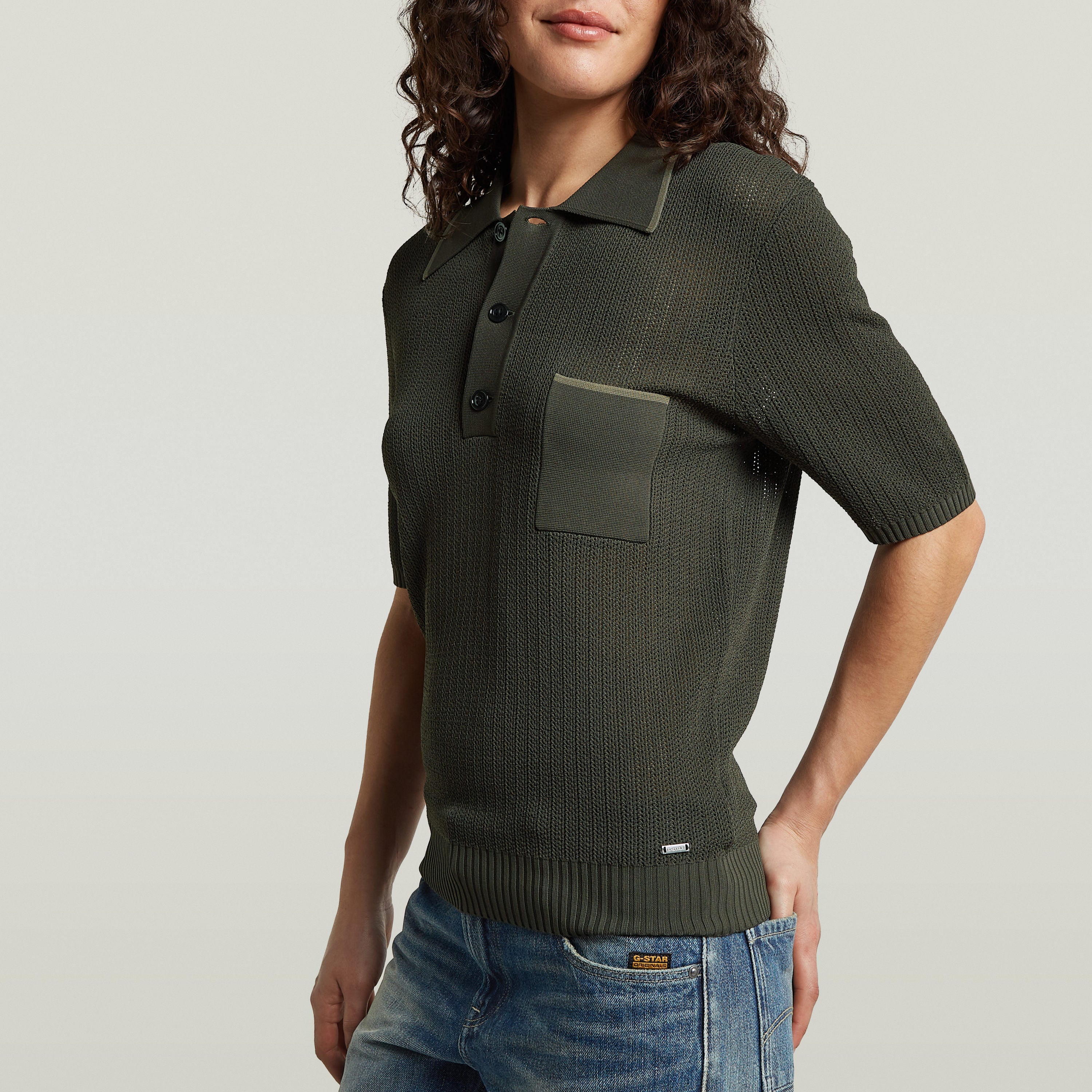 Structure Polo Knit in olive green, a classic knit polo shirt with button closure and a chest pocket.