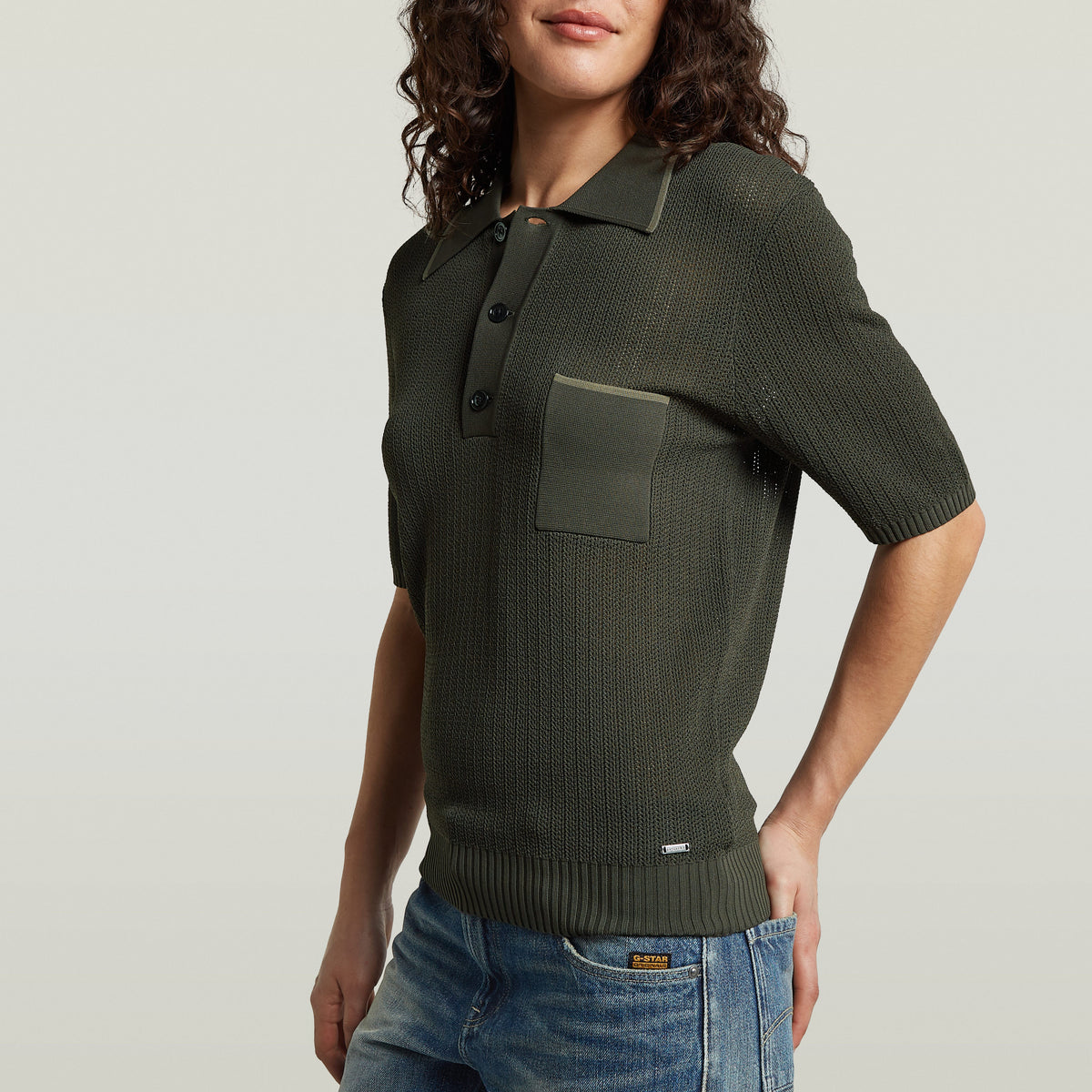 Structure Polo Knit in olive green, a classic knit polo shirt with button closure and a chest pocket.
