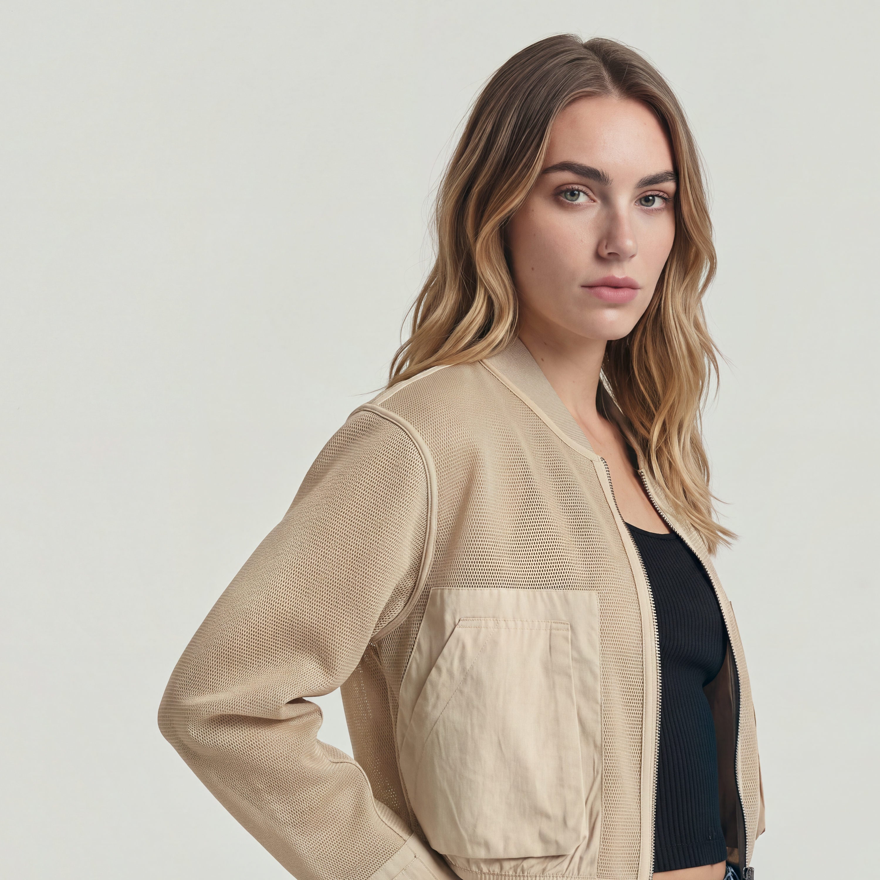 Model wearing a Mixed Media relaxed zip thru sweater with a relaxed fit and zipper closure.