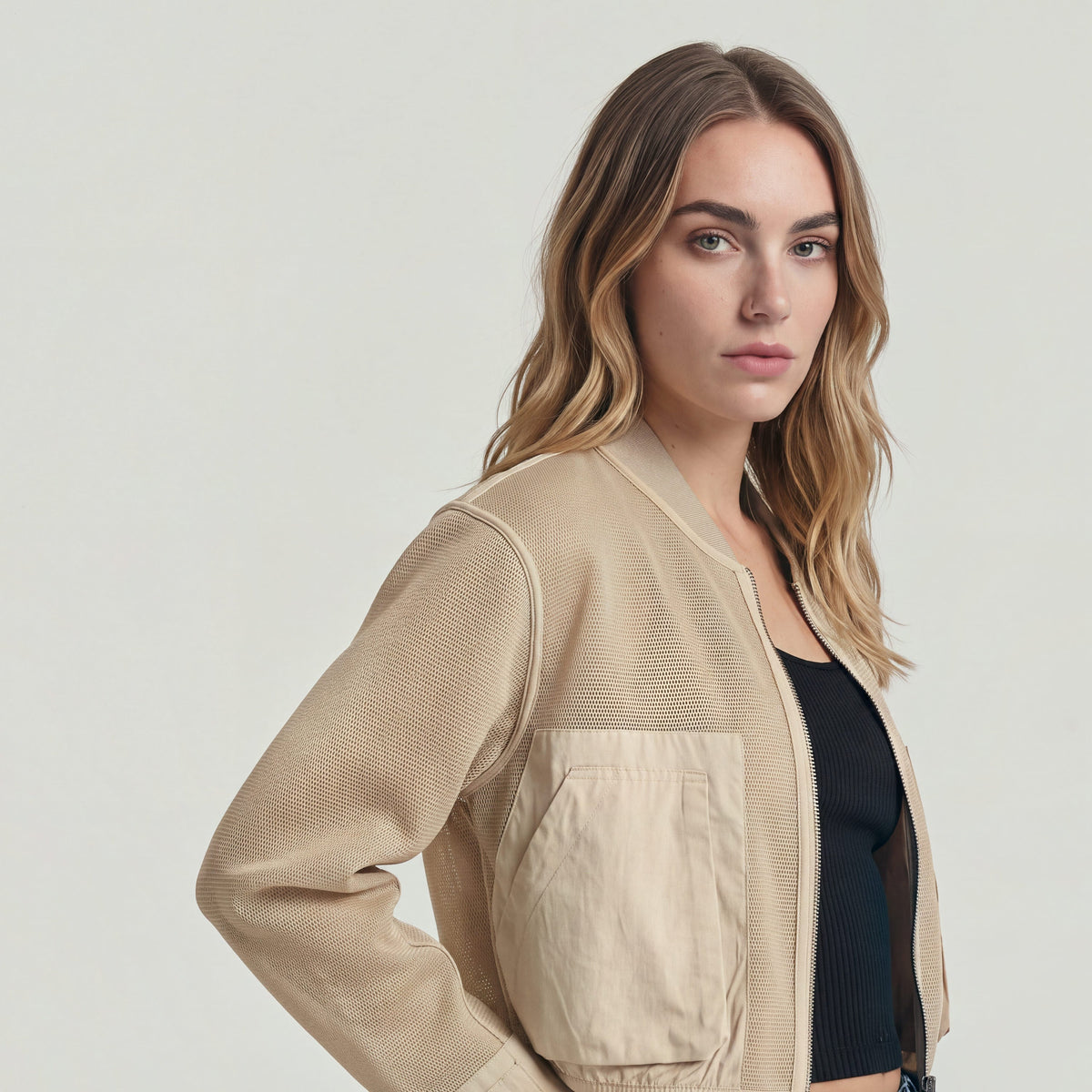 Model wearing a Mixed Media relaxed zip thru sweater with a relaxed fit and zipper closure.