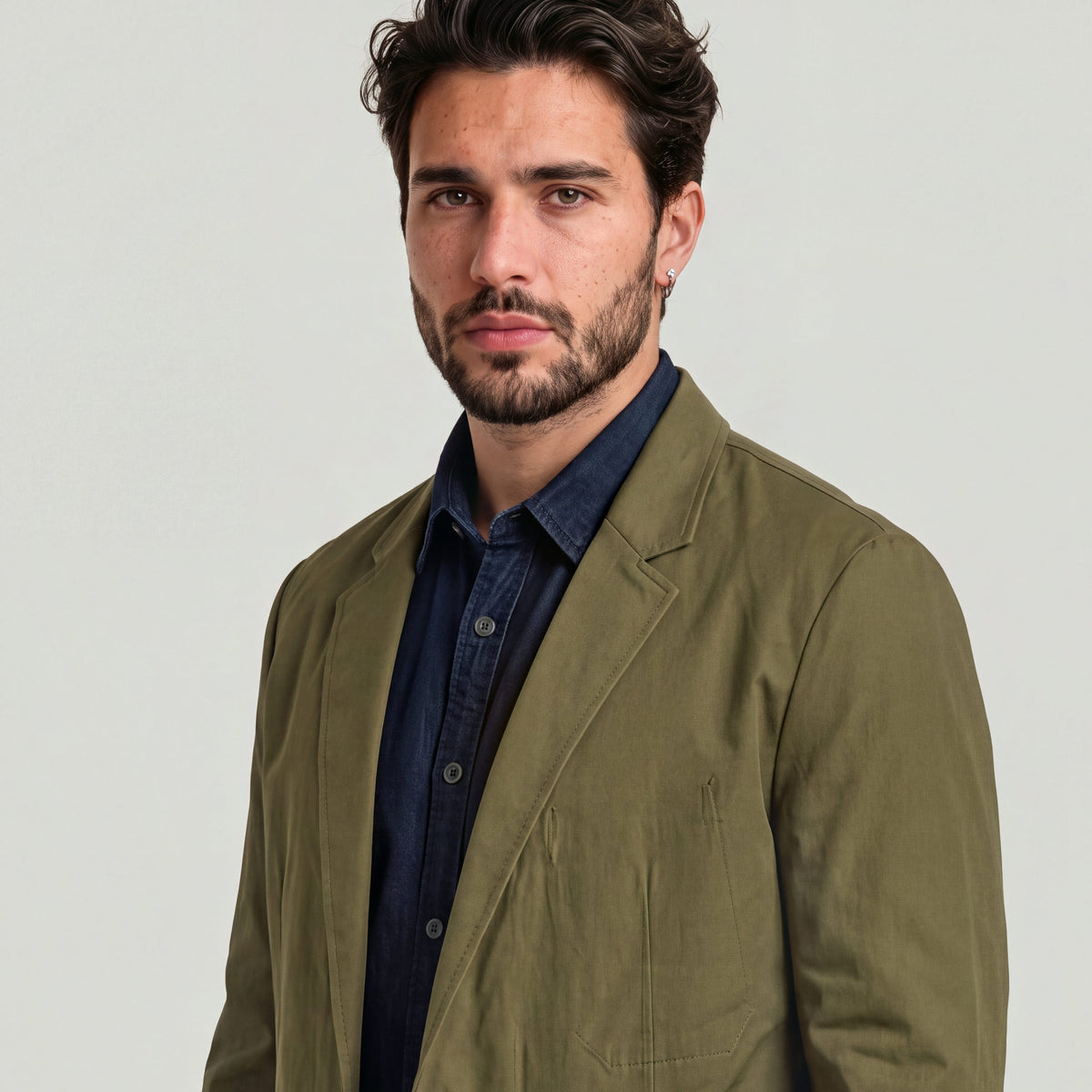 Sport blazer for versatile style worn by a man with a stylish look, featuring a relaxed fit and classic lapel design.