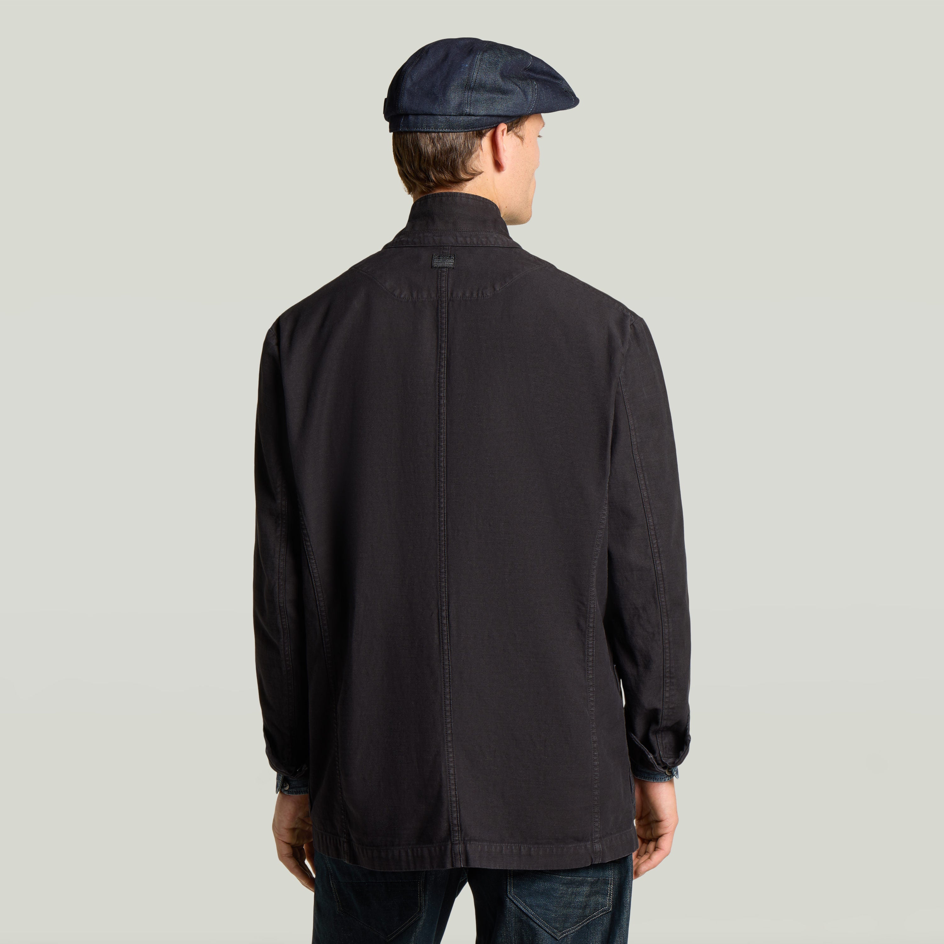 Casual sport blazer displayed from the back view with a modern design and stylish cap.