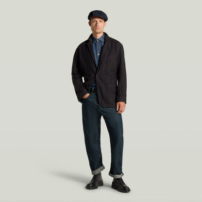 Casual sport blazer featured on a model, paired with a denim shirt and rolled-up jeans, showcasing stylish versatility.