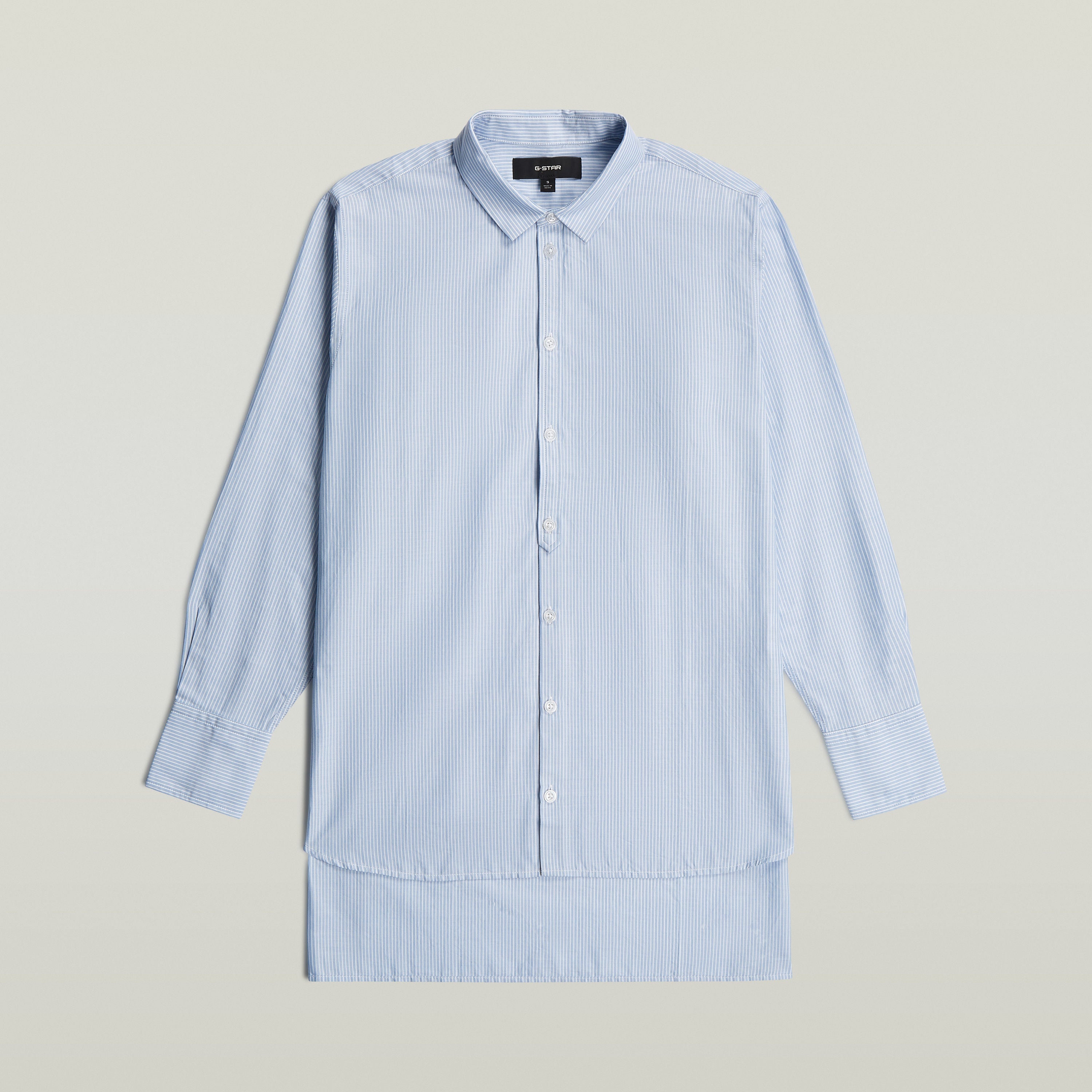Relaxed Step Hem Shirt in light blue with vertical stripes and button closure.
