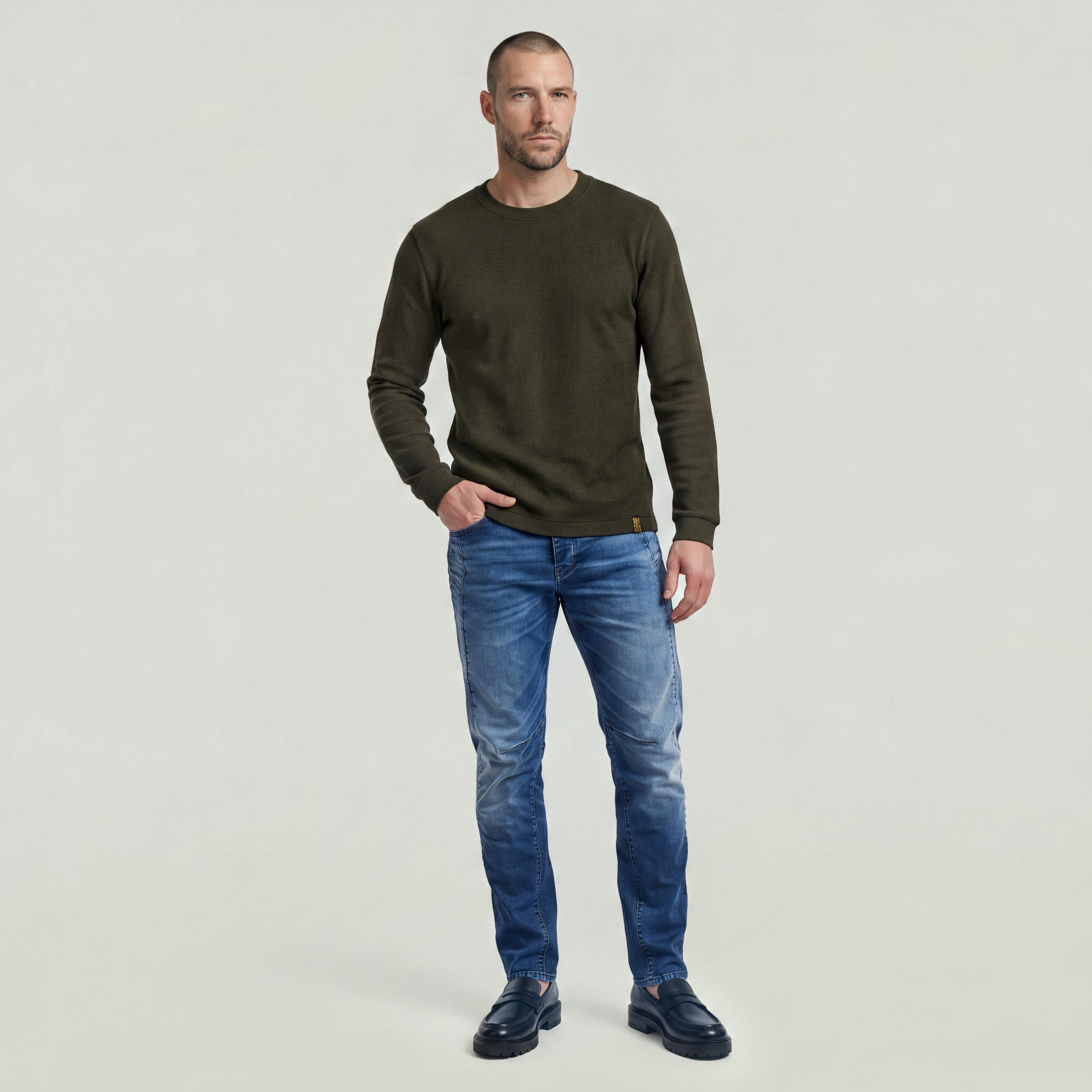 Man wearing a brushed long sleeve t-shirt with jeans, showcasing a casual and stylish outfit.