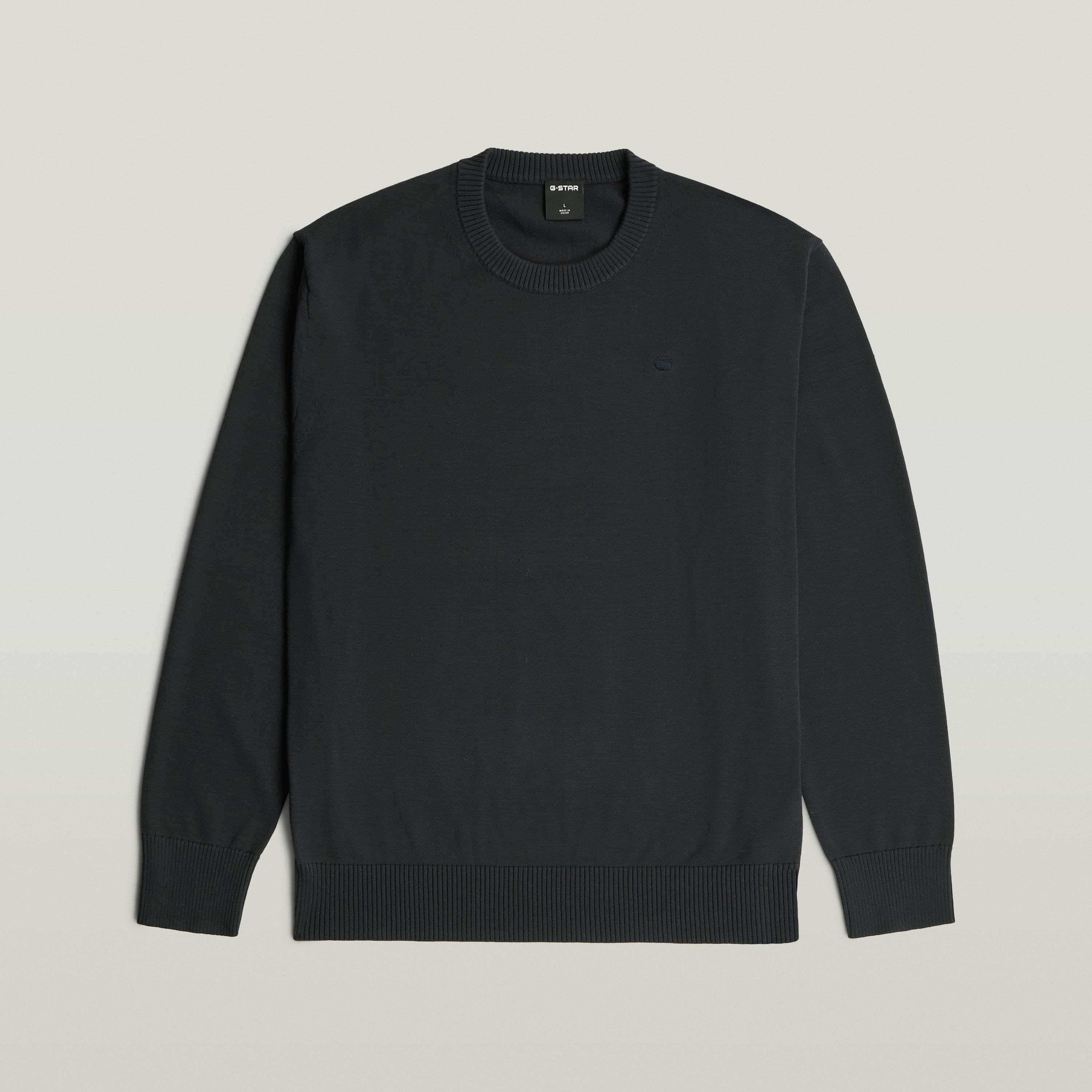 Core Refined Knit Pullover, a classic knit pullover with a round neck and long sleeves in black.