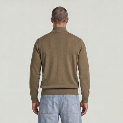 Back view of a man wearing the Core Refined Half Zip Knit sweater in olive green.