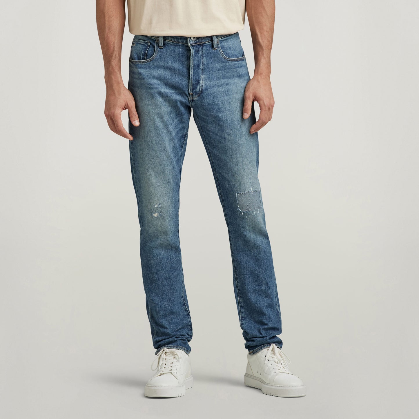 G-Star 3301 slim jeans on a model, showcasing the medium indigo denim and a slim fit design with five-pocket style.