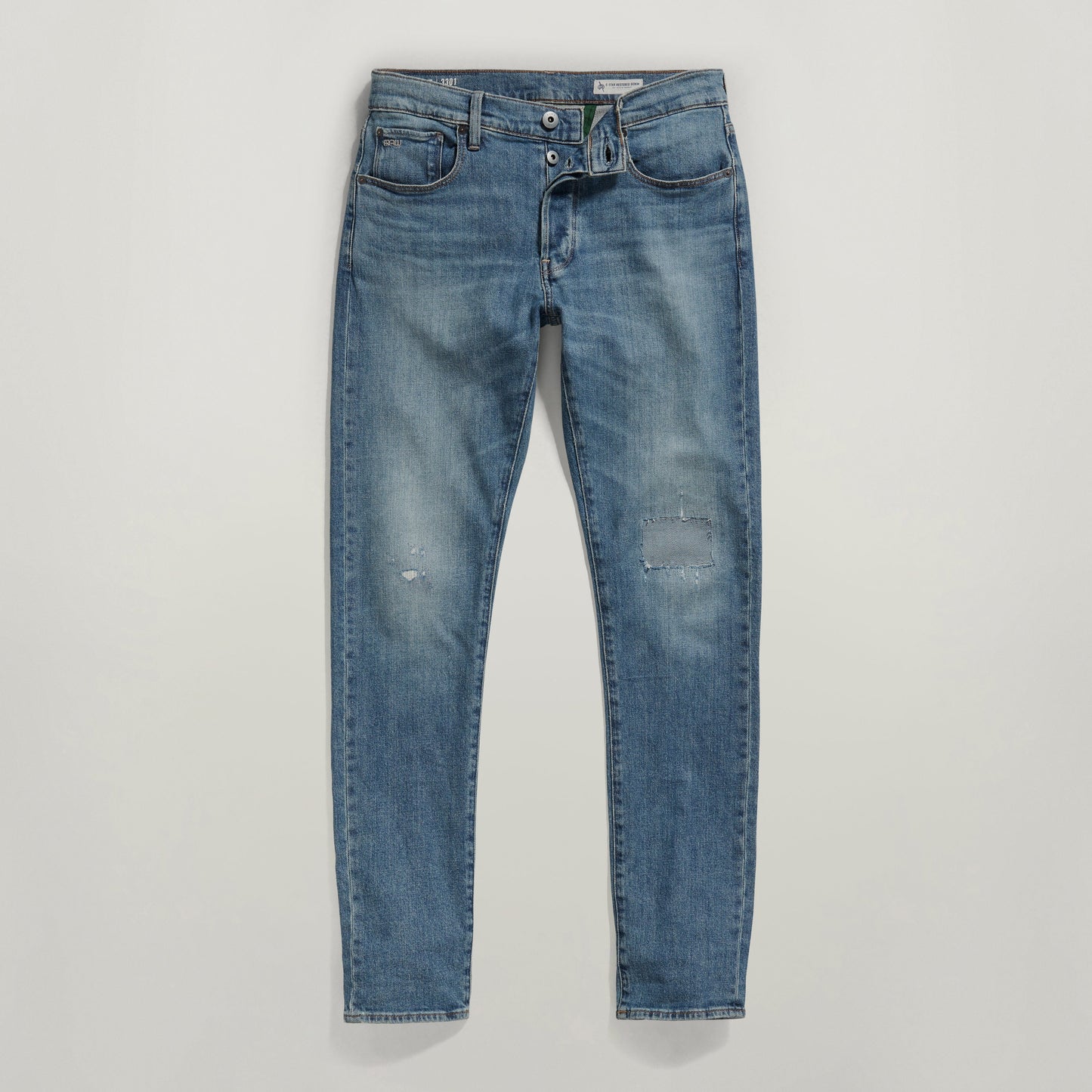 G-Star 3301 slim jeans in medium indigo with distressed details and five-pocket design.