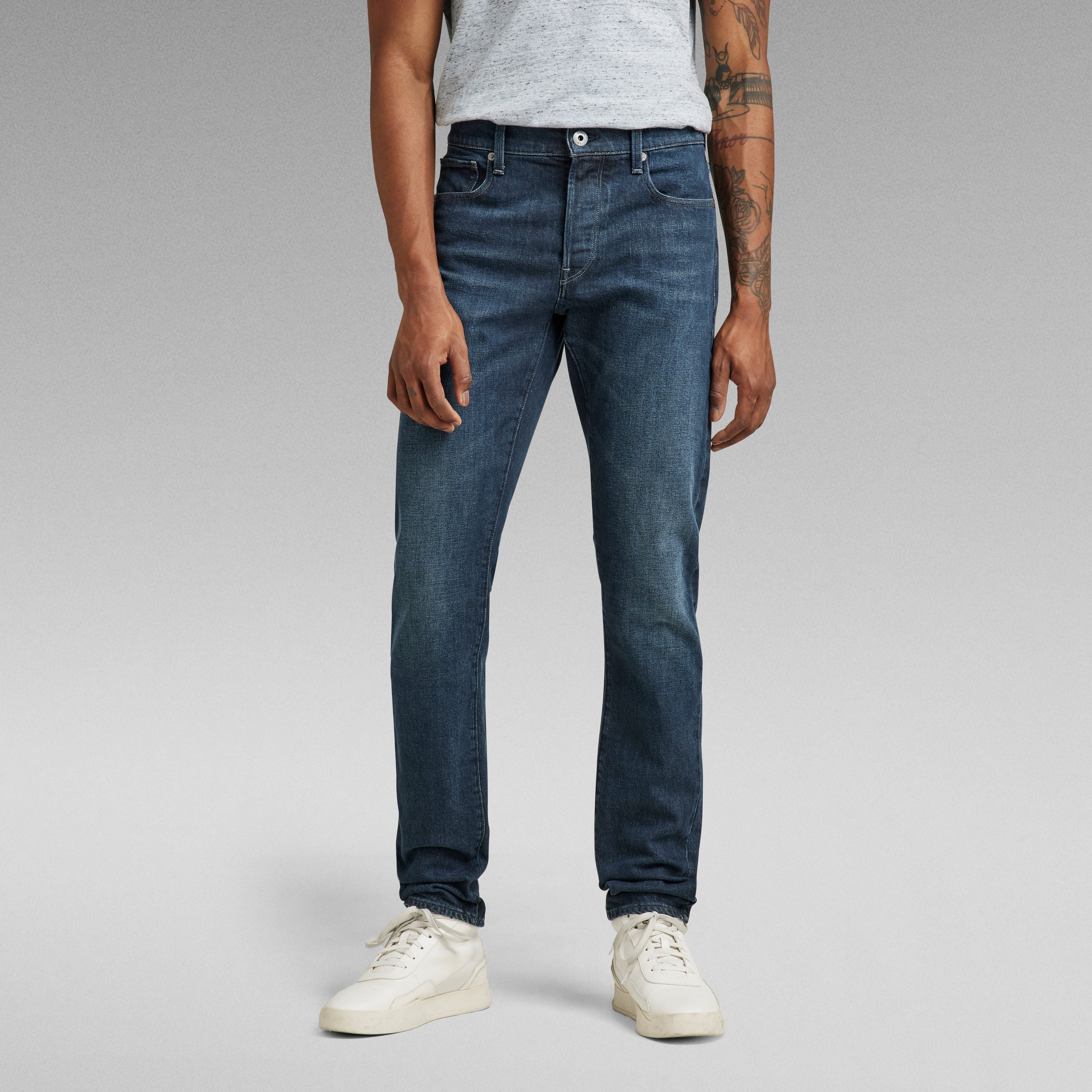 G-Star 3301 slim jeans worn by a man with a casual outfit, showcasing a fitted look and five-pocket design.
