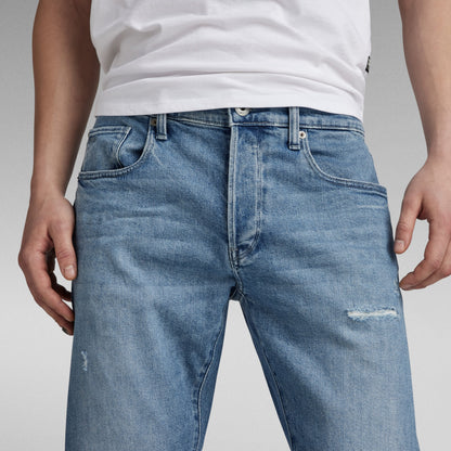 G-Star 3301 slim jeans worn by a model, showcasing the classic five-pocket design and button fly.