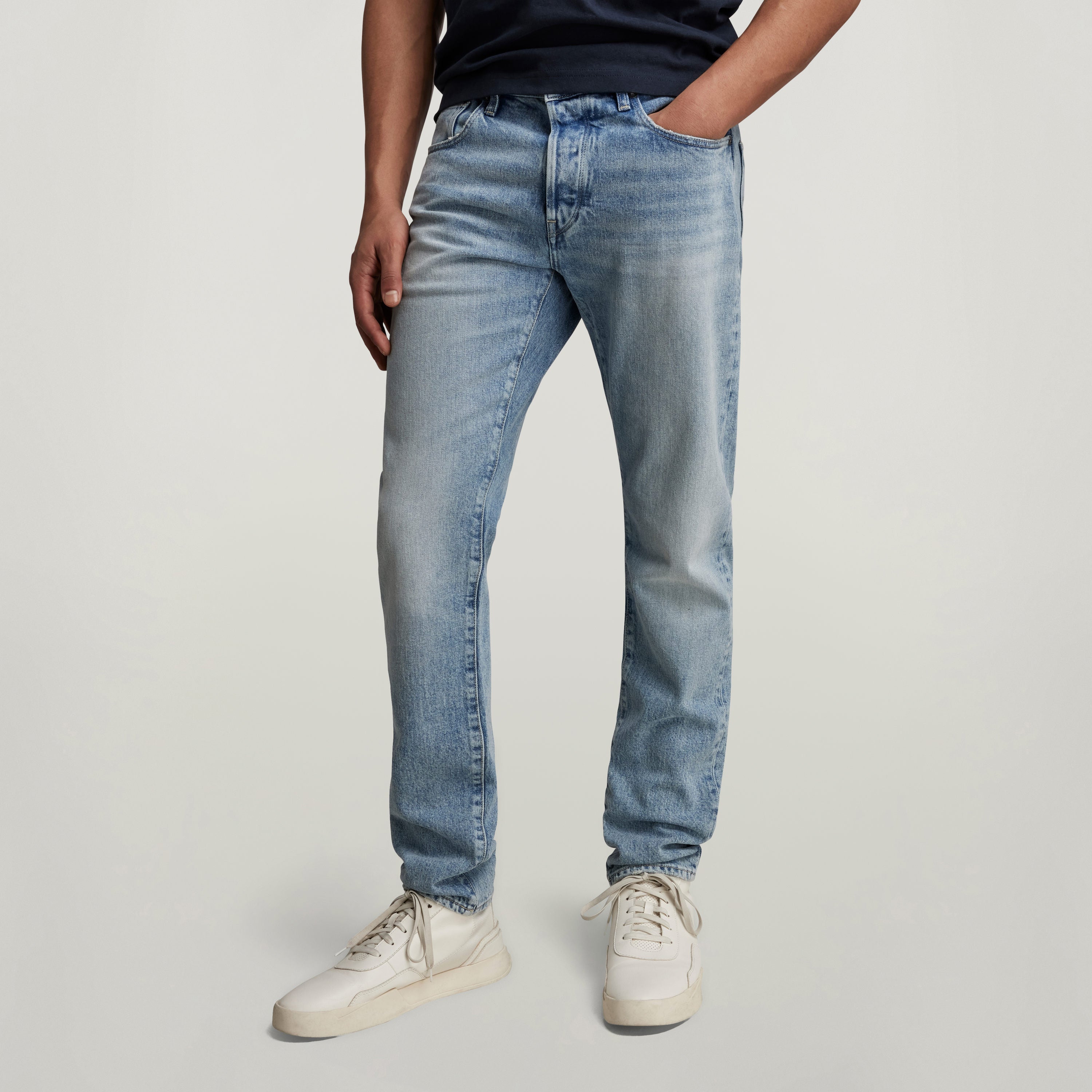 G-Star 3301 slim jeans worn by a model, showcasing a classic five-pocket design and medium waist.
