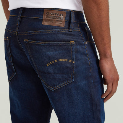 G-Star 3301 Straight jeans detail showing back pockets and logo on the waistband in dark denim.