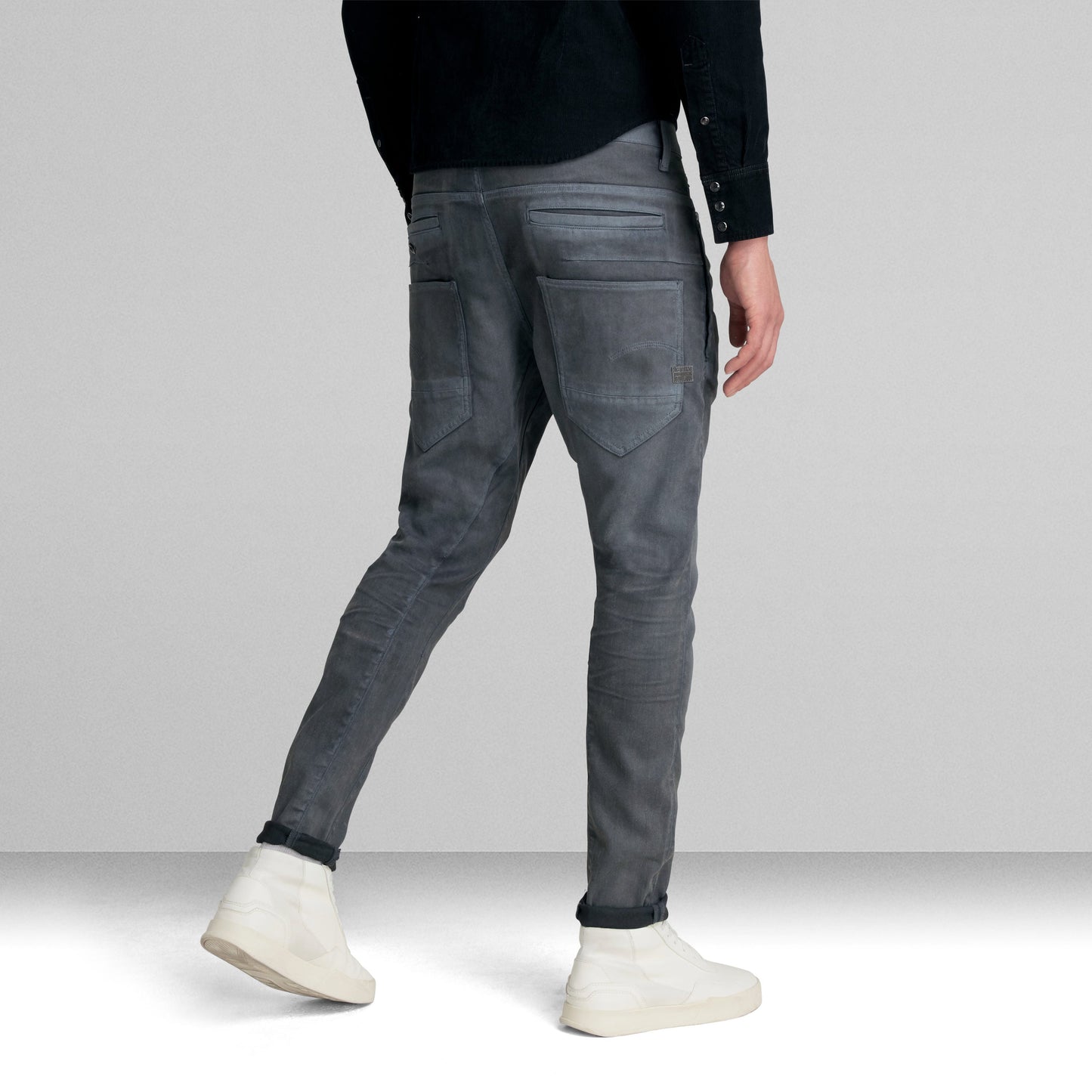 D-Staq slim fit jeans showcased on a model from the back, featuring a sleek design with multiple pockets.