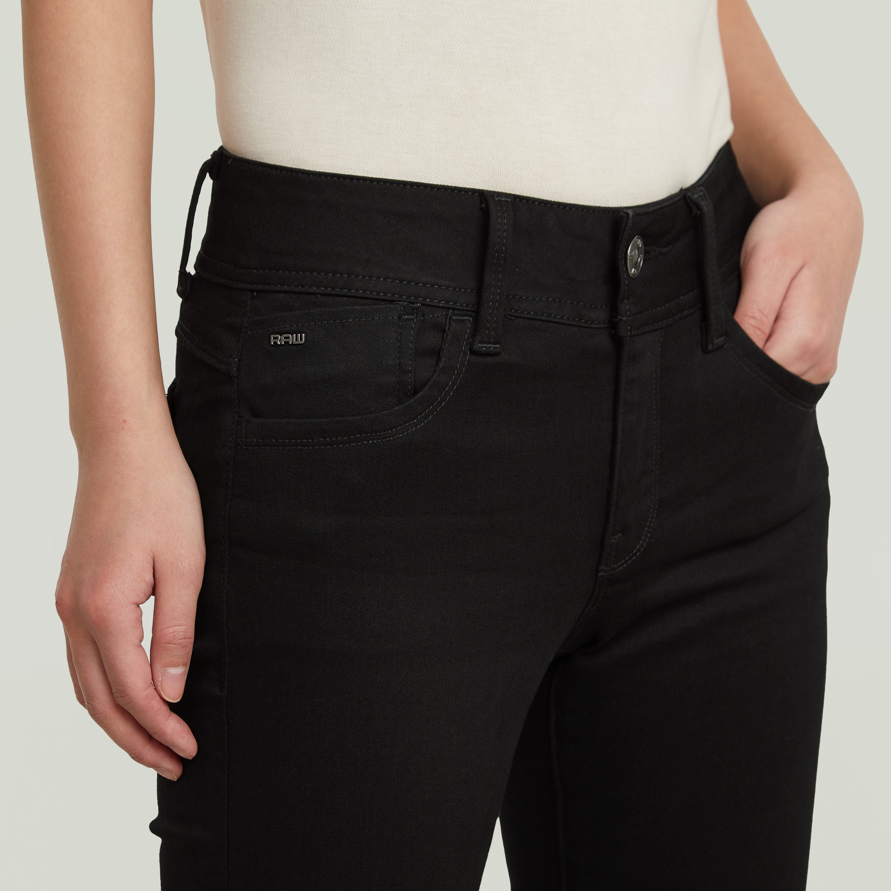 Lynn super skinny jeans in black showcasing a modern fit and five-pocket style at waist level.