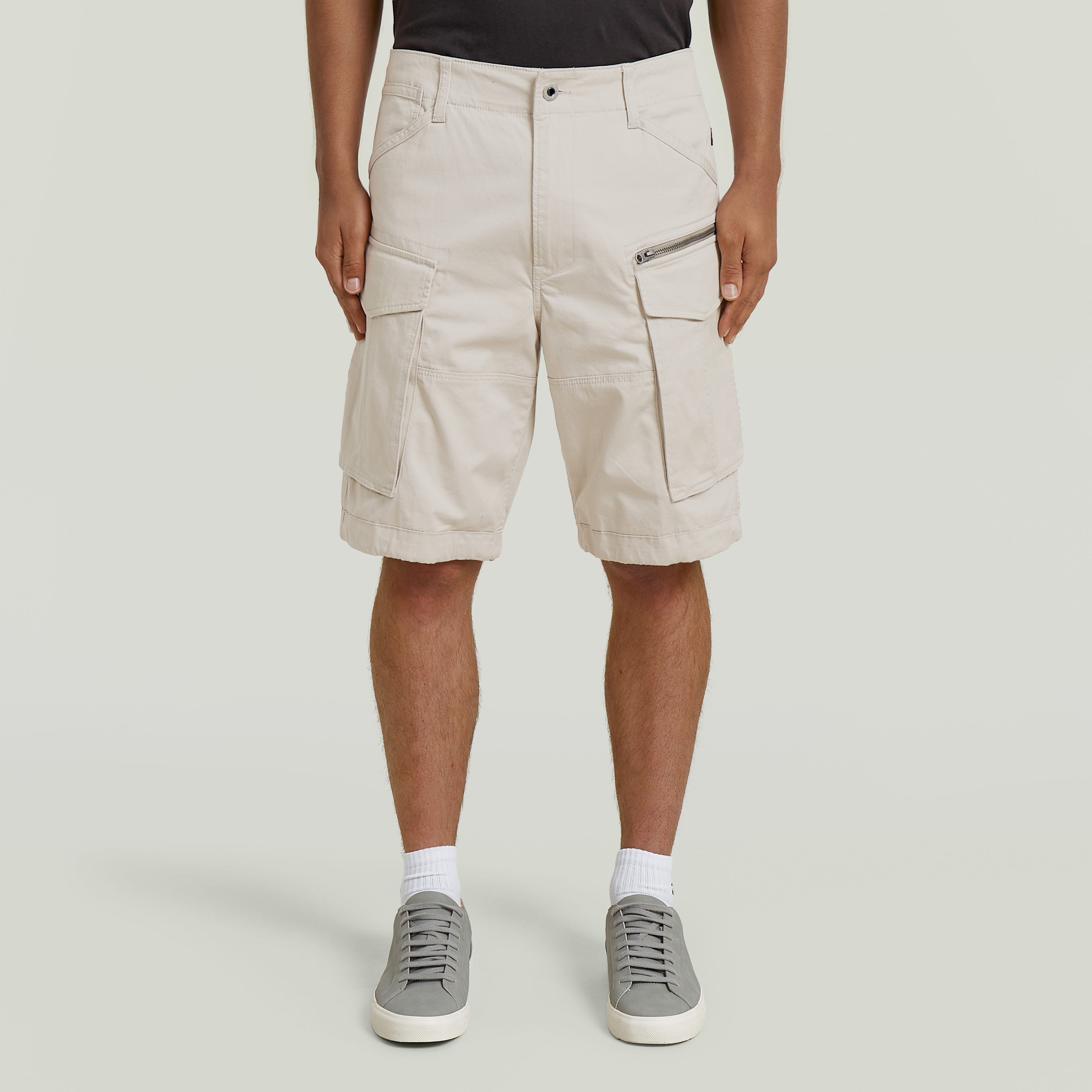 relaxed fit zip shorts in beige with functional pockets and comfortable fit.