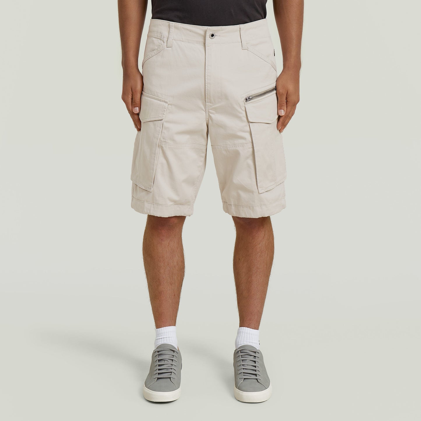 relaxed fit zip shorts in beige with functional pockets and comfortable fit.