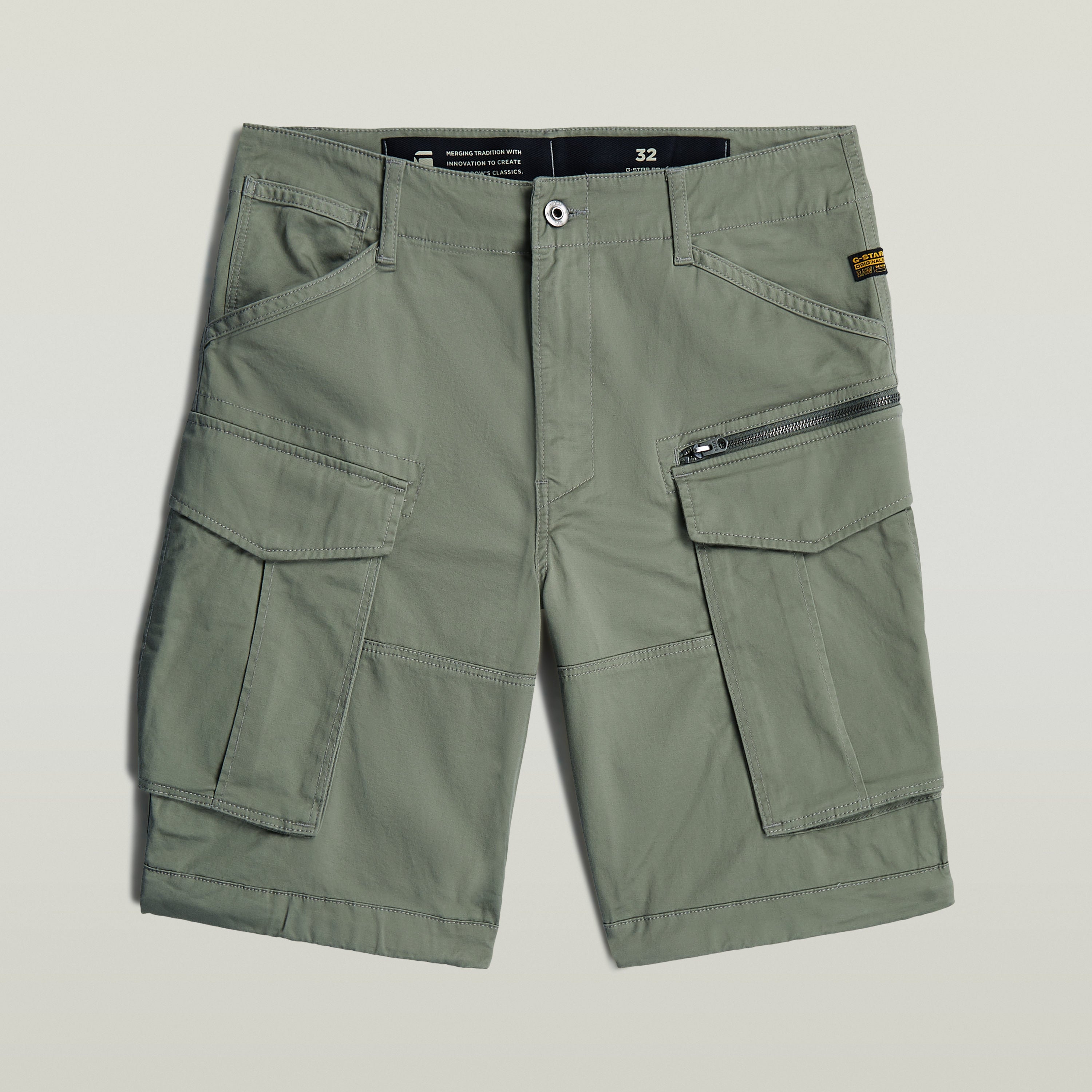 relaxed fit Rovic zip shorts in green with multiple functional pockets and zip closure.