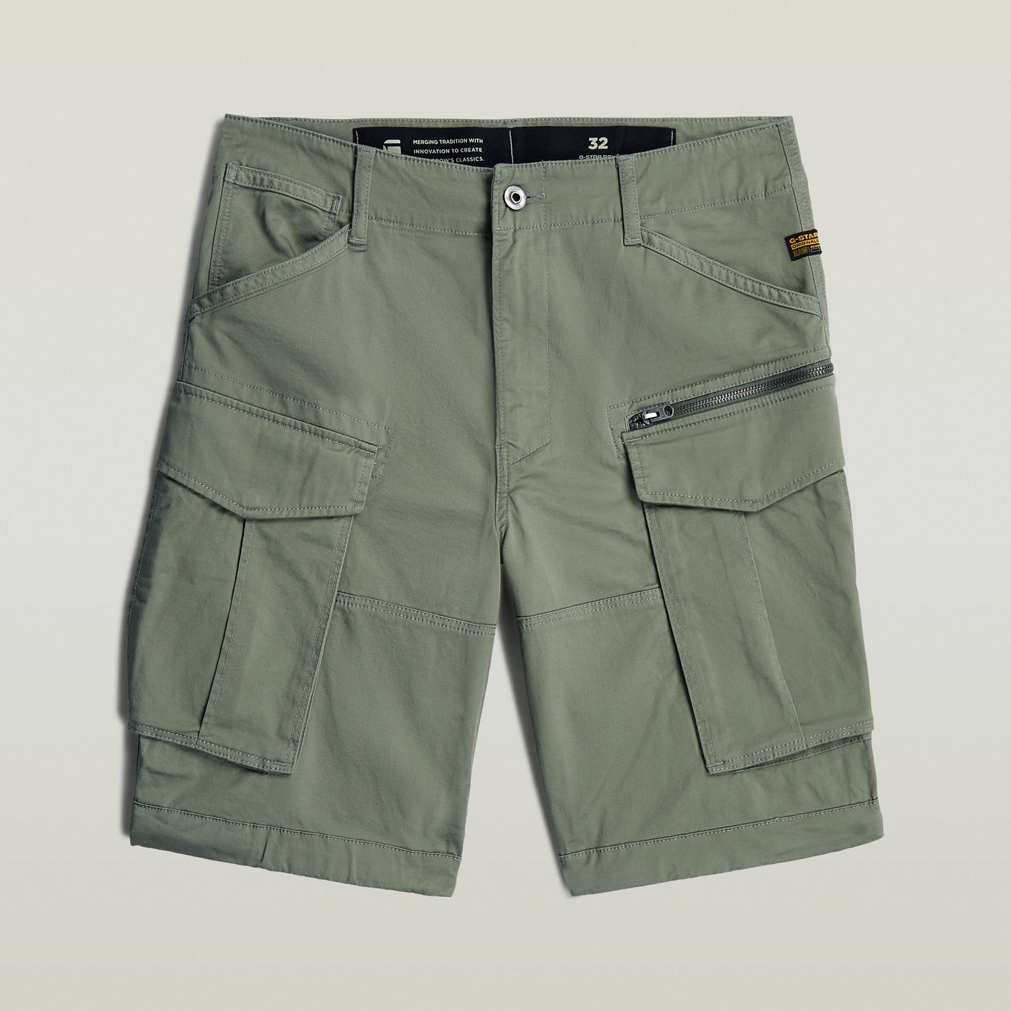 relaxed fit Rovic zip shorts in green with multiple functional pockets and zip closure.