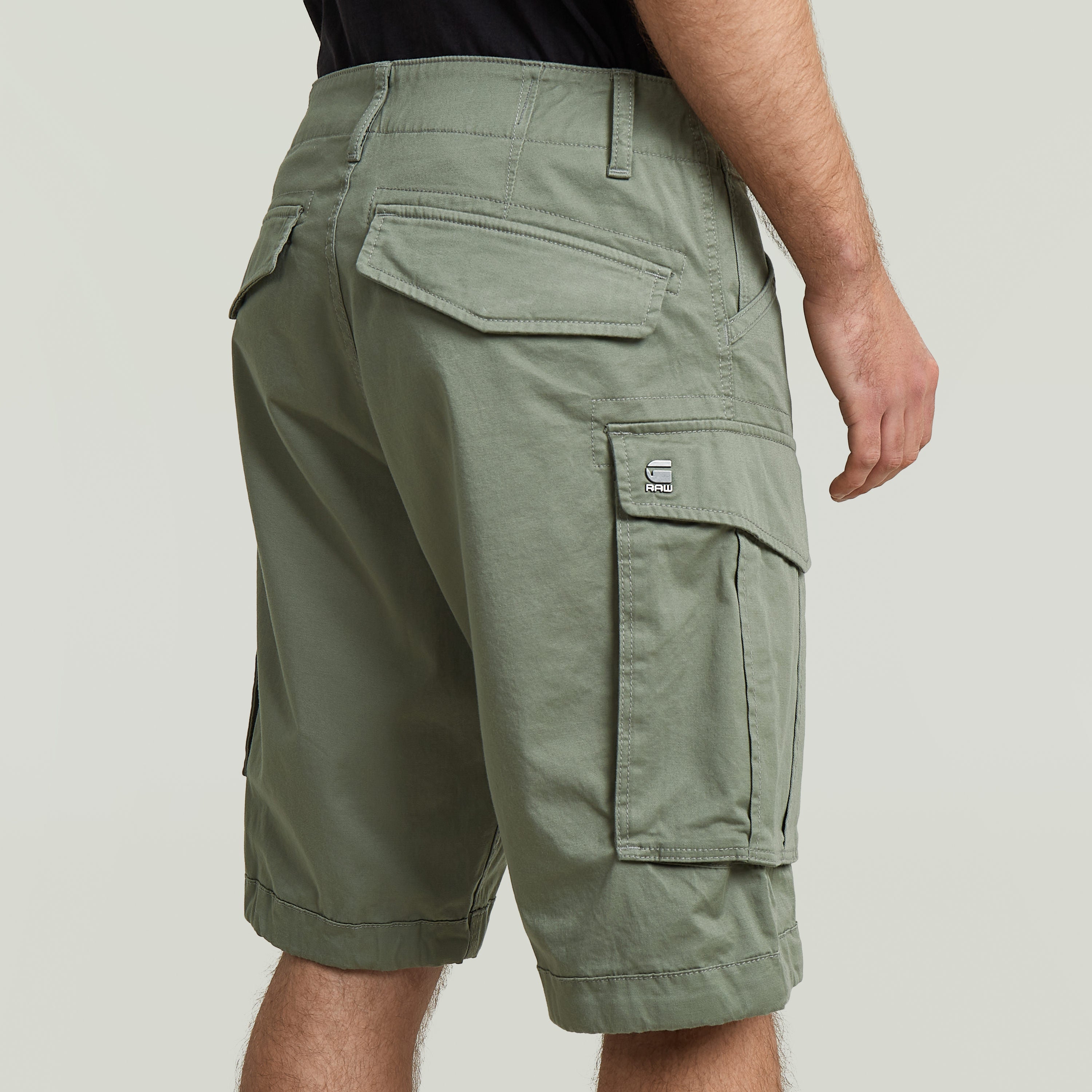 Relaxed fit Rovic zip shorts showcasing multiple pockets and a durable design in green color.