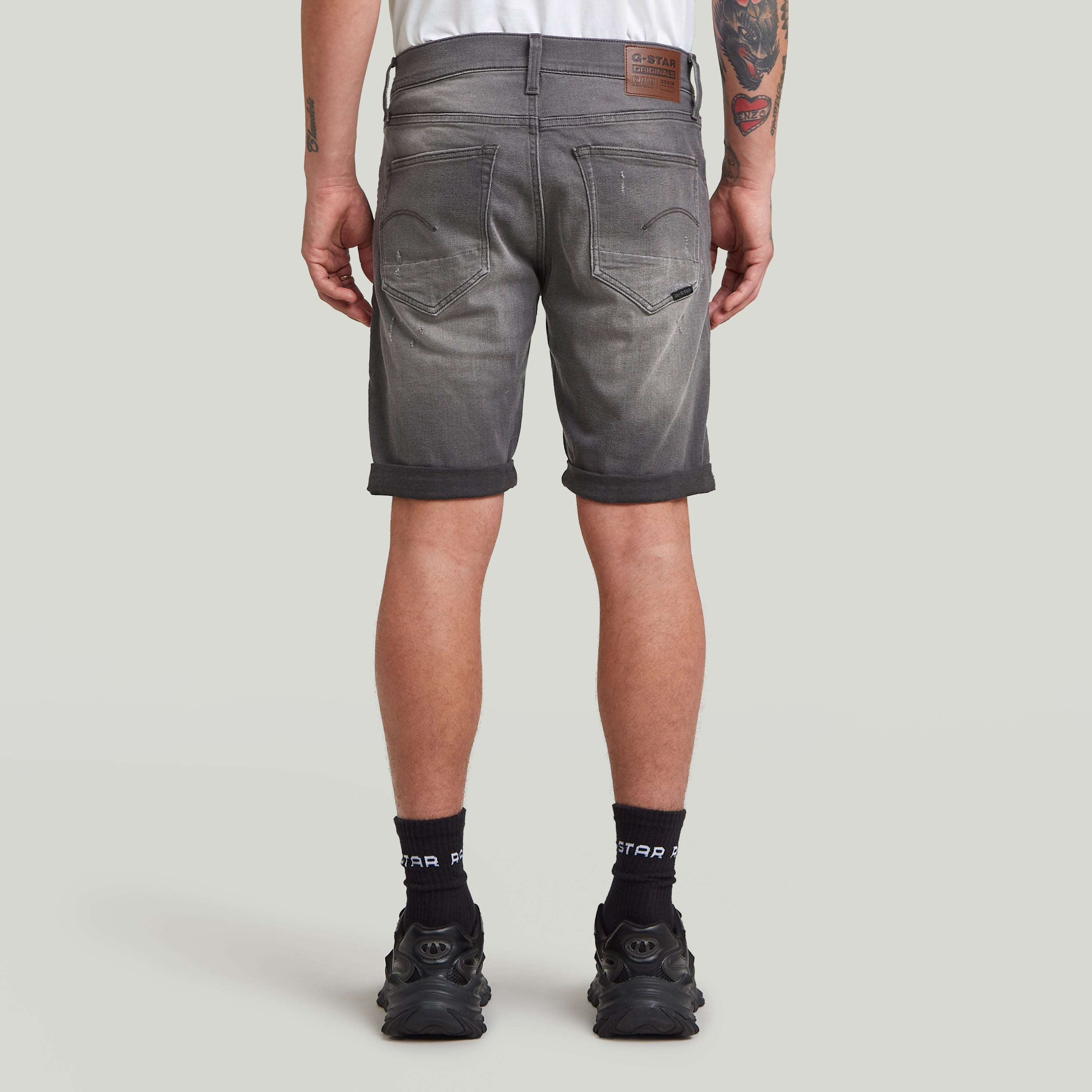 G-Star 3301 slim denim shorts shown from the back, featuring a five-pocket design and rolled hem.