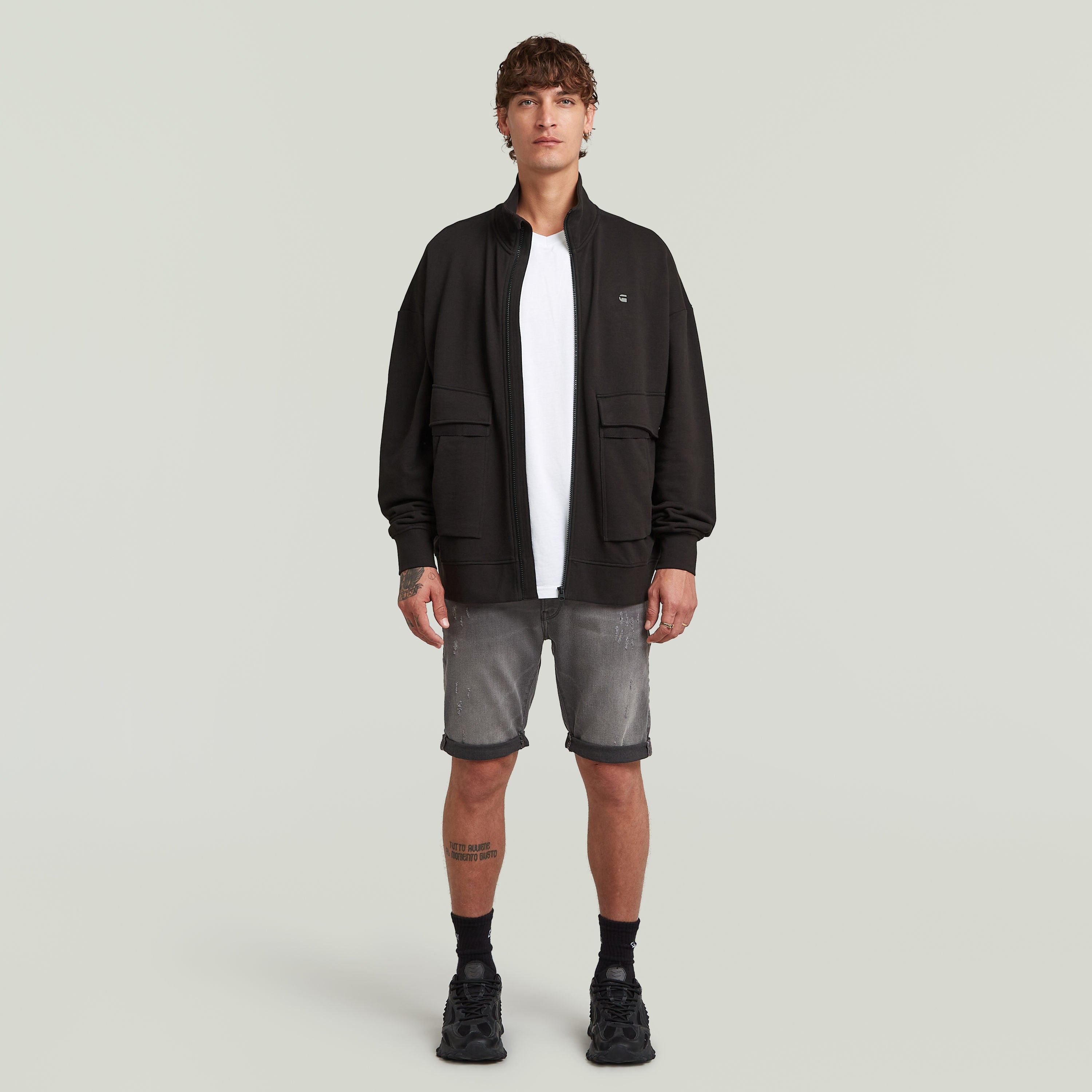 G-Star 3301 slim denim shorts paired with a black jacket and white t-shirt on a male model.