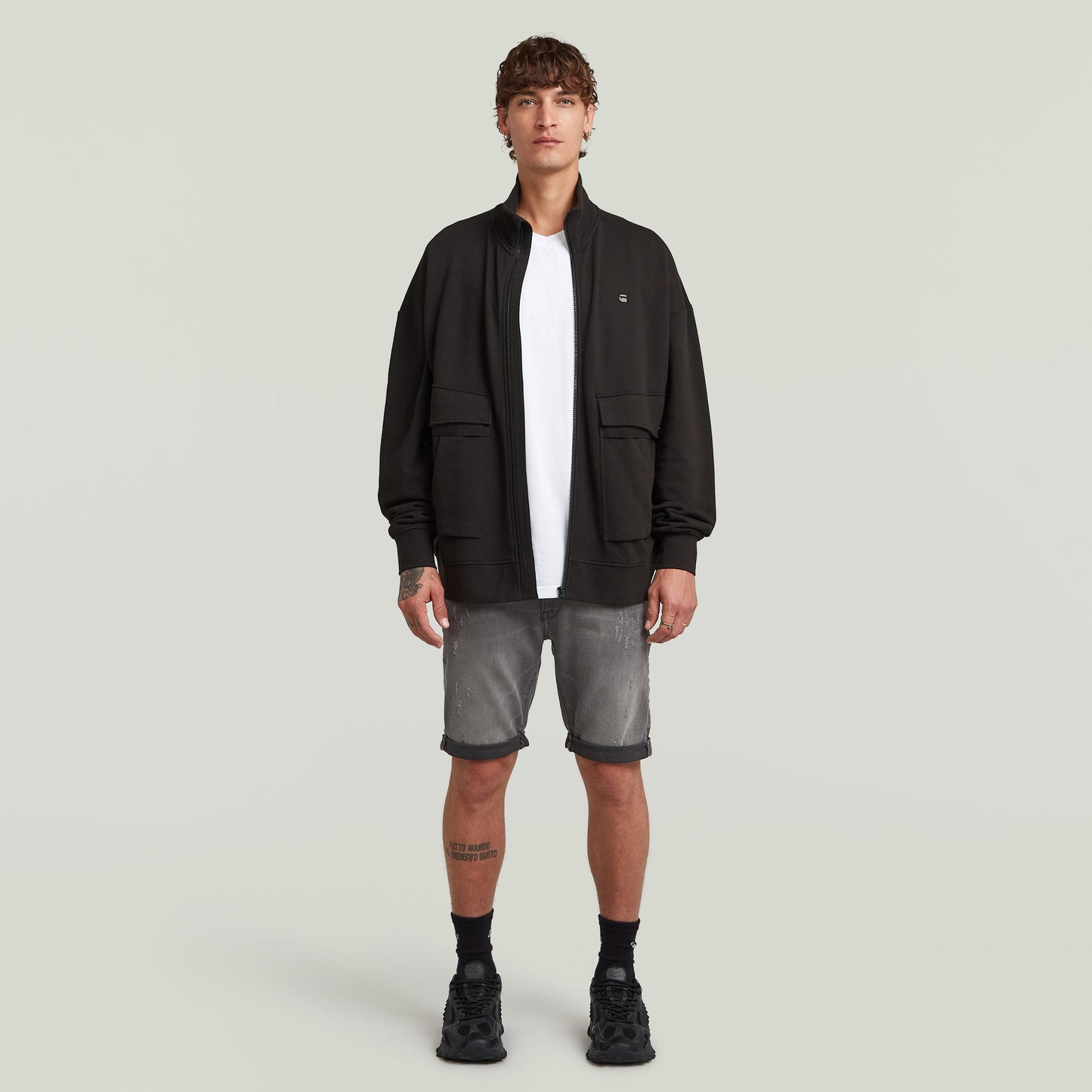 G-Star 3301 slim denim shorts paired with a black jacket and white t-shirt on a male model.