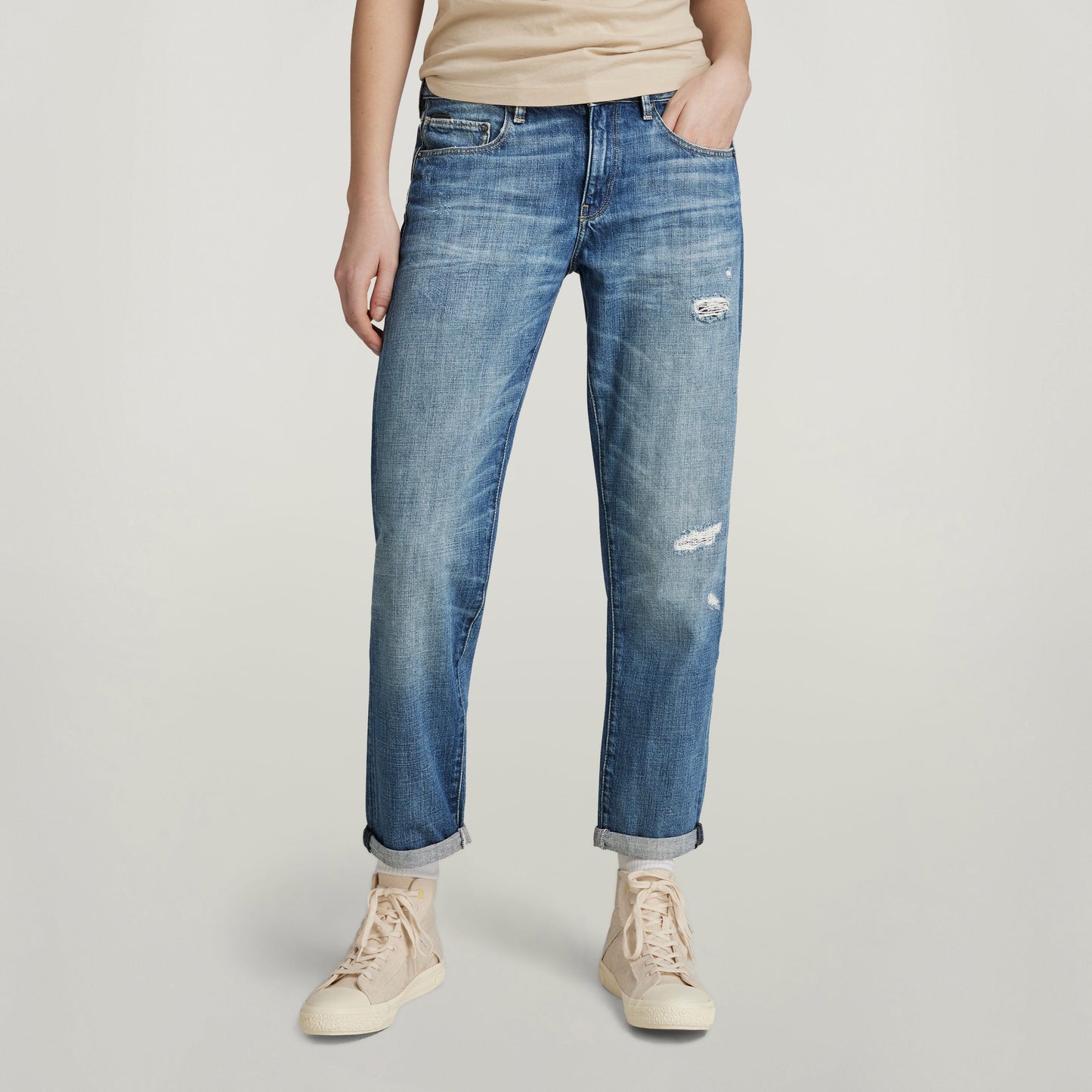 Mujer usando jeans Kate Boyfriend, corte relajado y moderno, con detalles desgastados y bajos doblados.