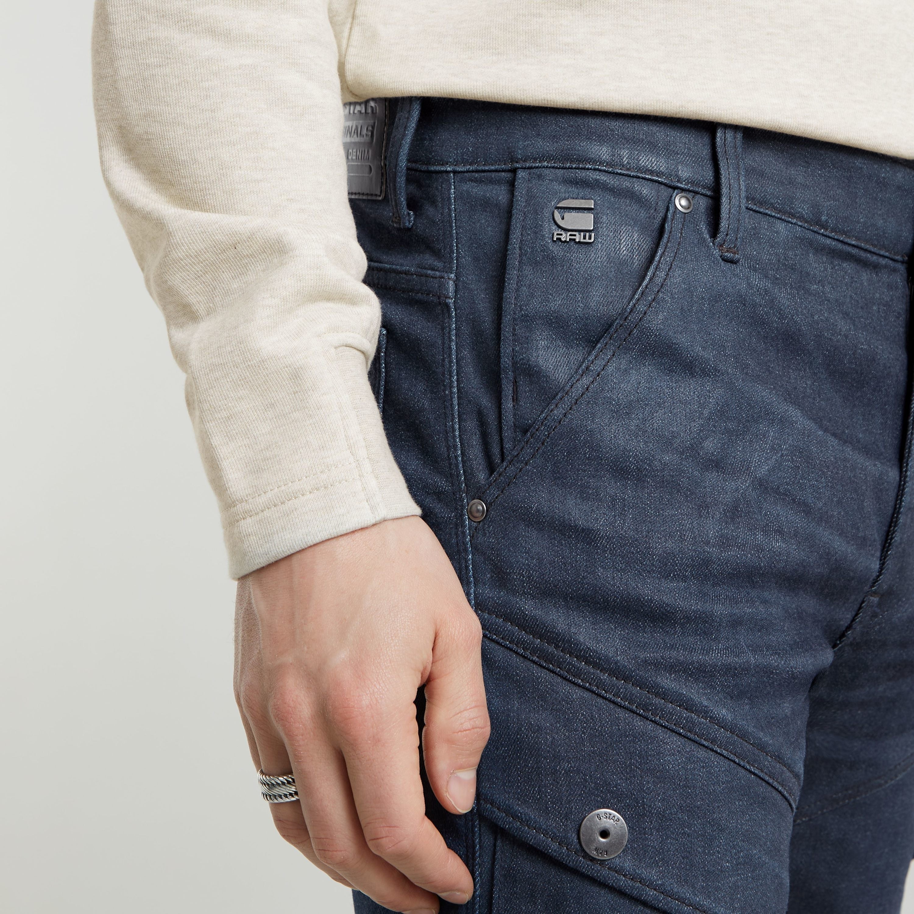 Close-up of a man's hand on Airblaze 3D skinny jeans, showcasing stylish pockets and modern design.