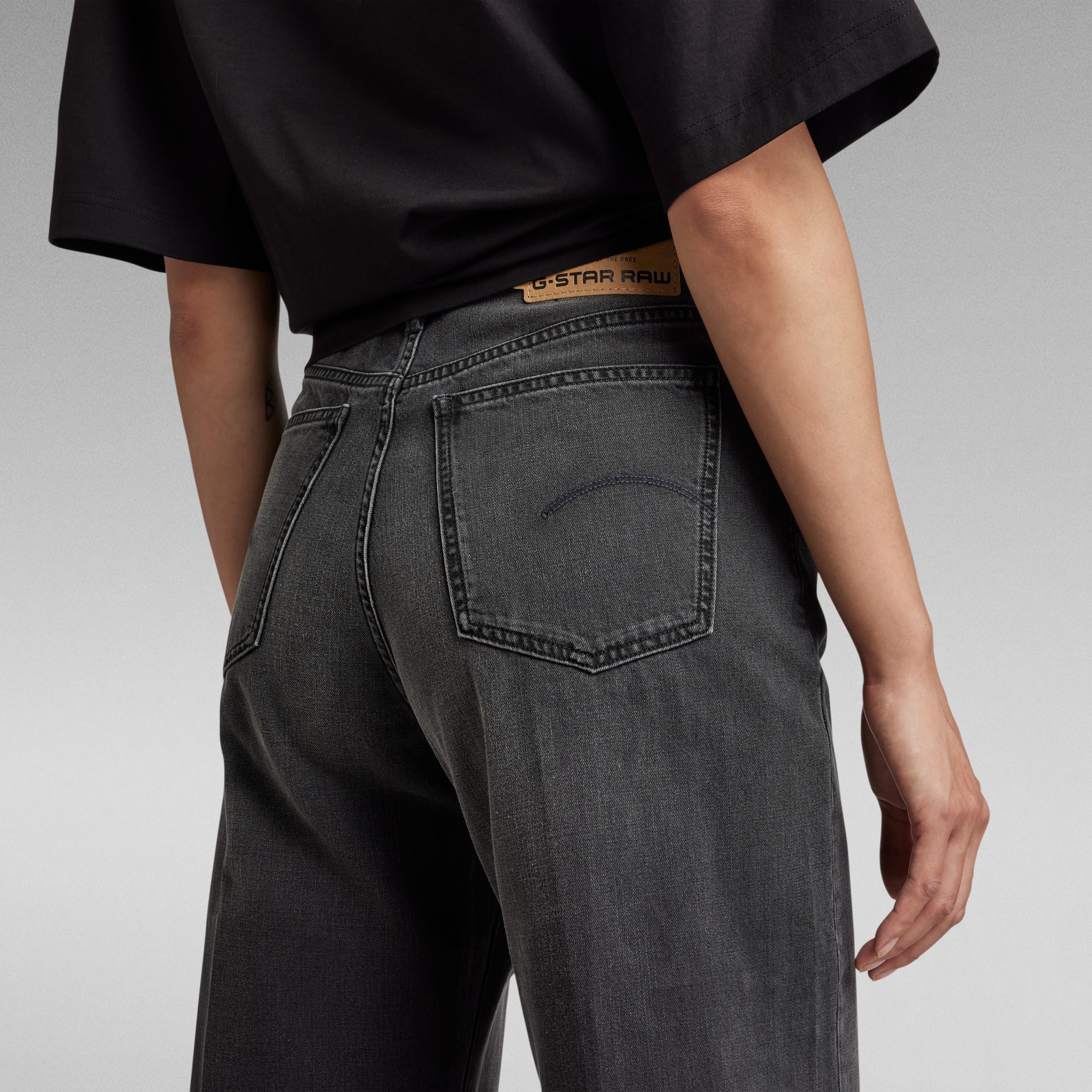 Close-up of a person wearing G-Star RAW ultra high wide leg jeans from the back, showcasing the pocket design.