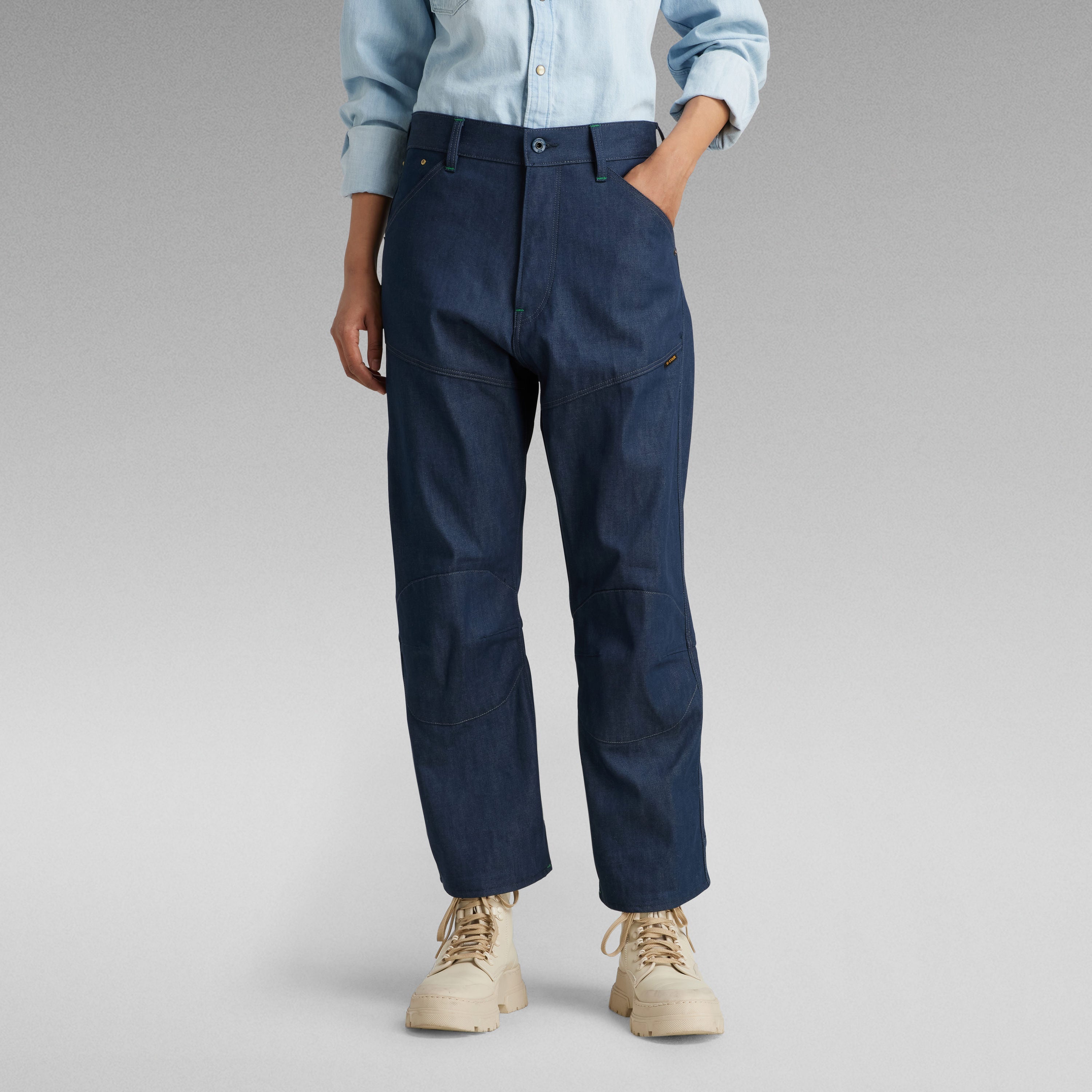 Bootcut jeans for women in dark blue with a casual shirt and beige boots, showcasing a stylish and comfortable fit.