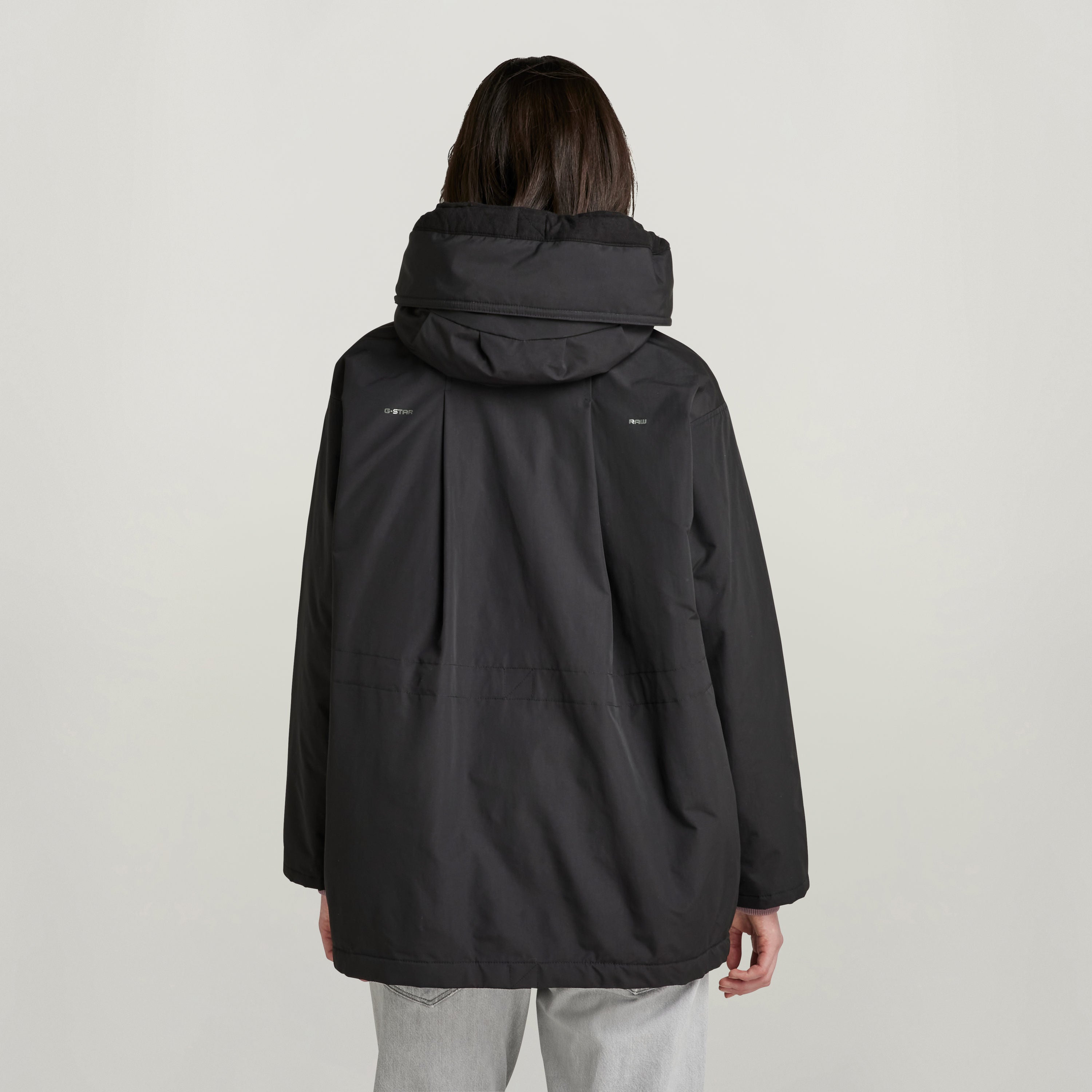 loose fit parka with hood, showing the back view with large hood and relaxed silhouette.