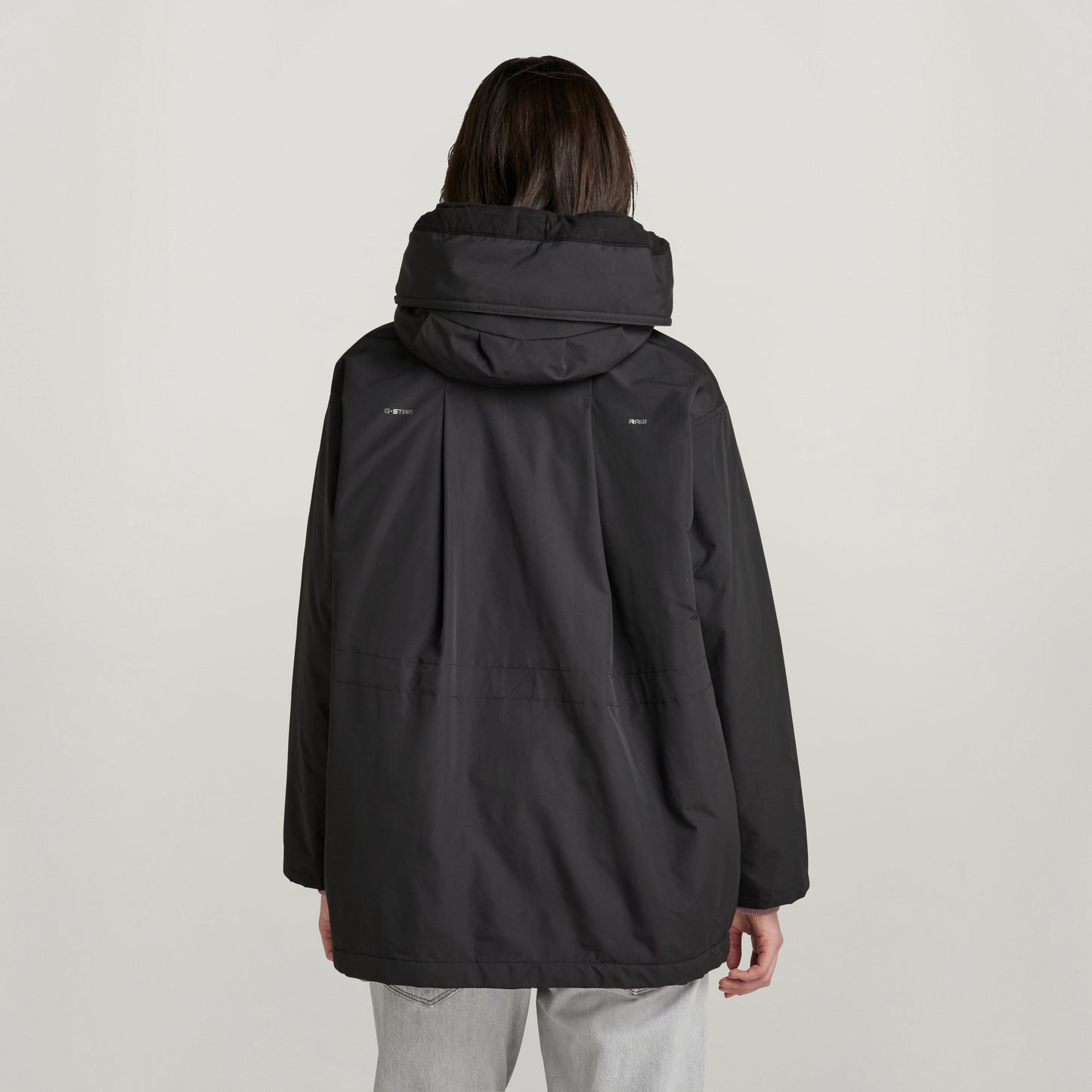 loose fit parka with hood, showing the back view with large hood and relaxed silhouette.