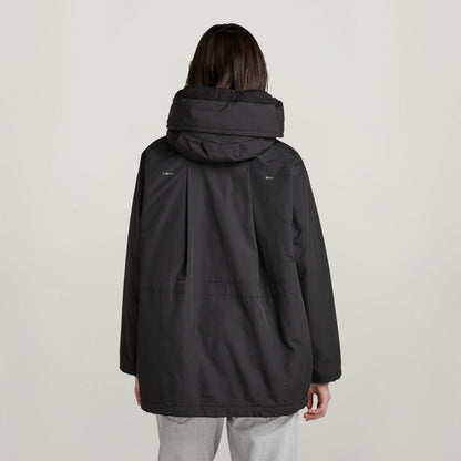 loose fit parka with hood, showing the back view with large hood and relaxed silhouette.