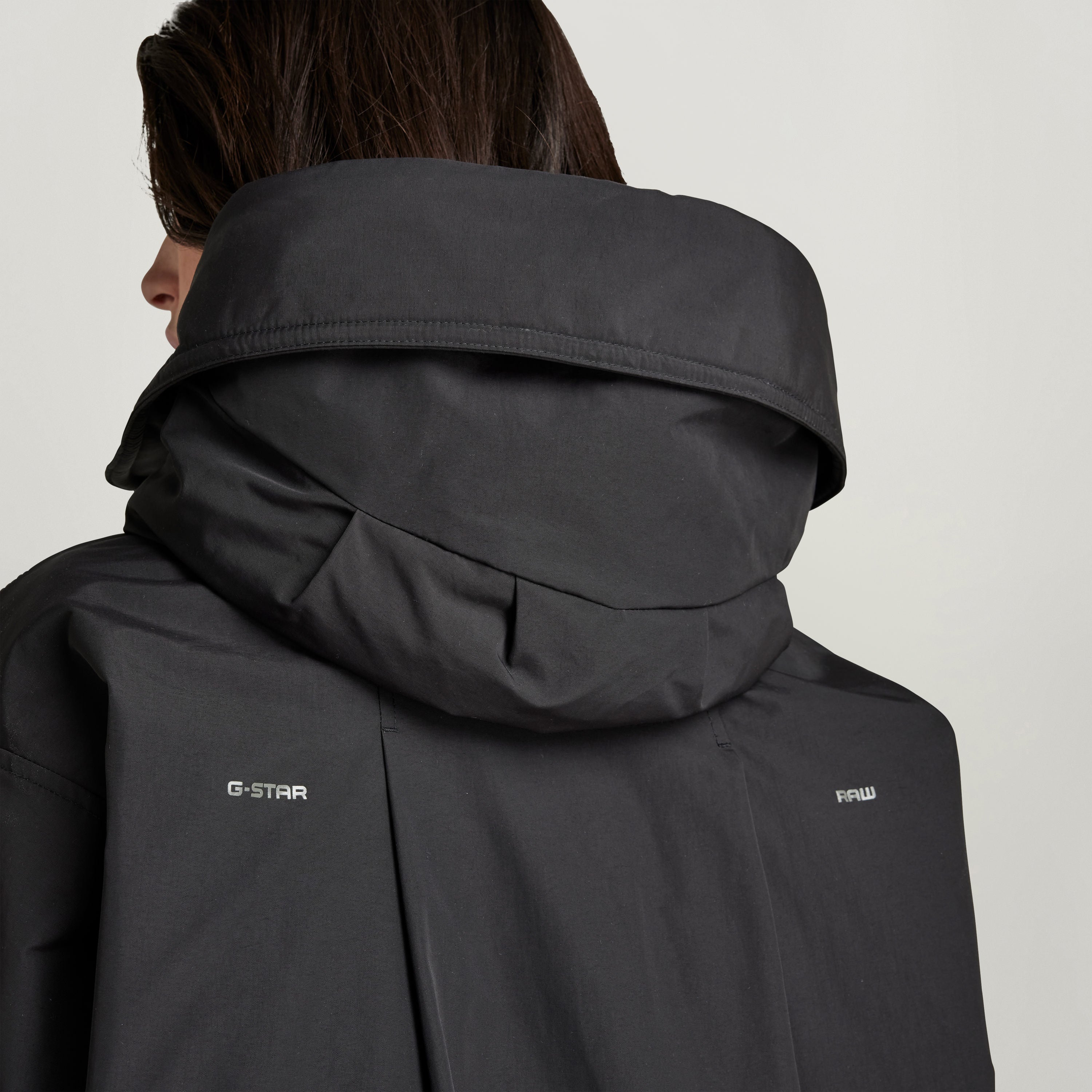 Loose fit parka with hood featuring a high collar and adjustable drawstrings, perfect for versatile styling.