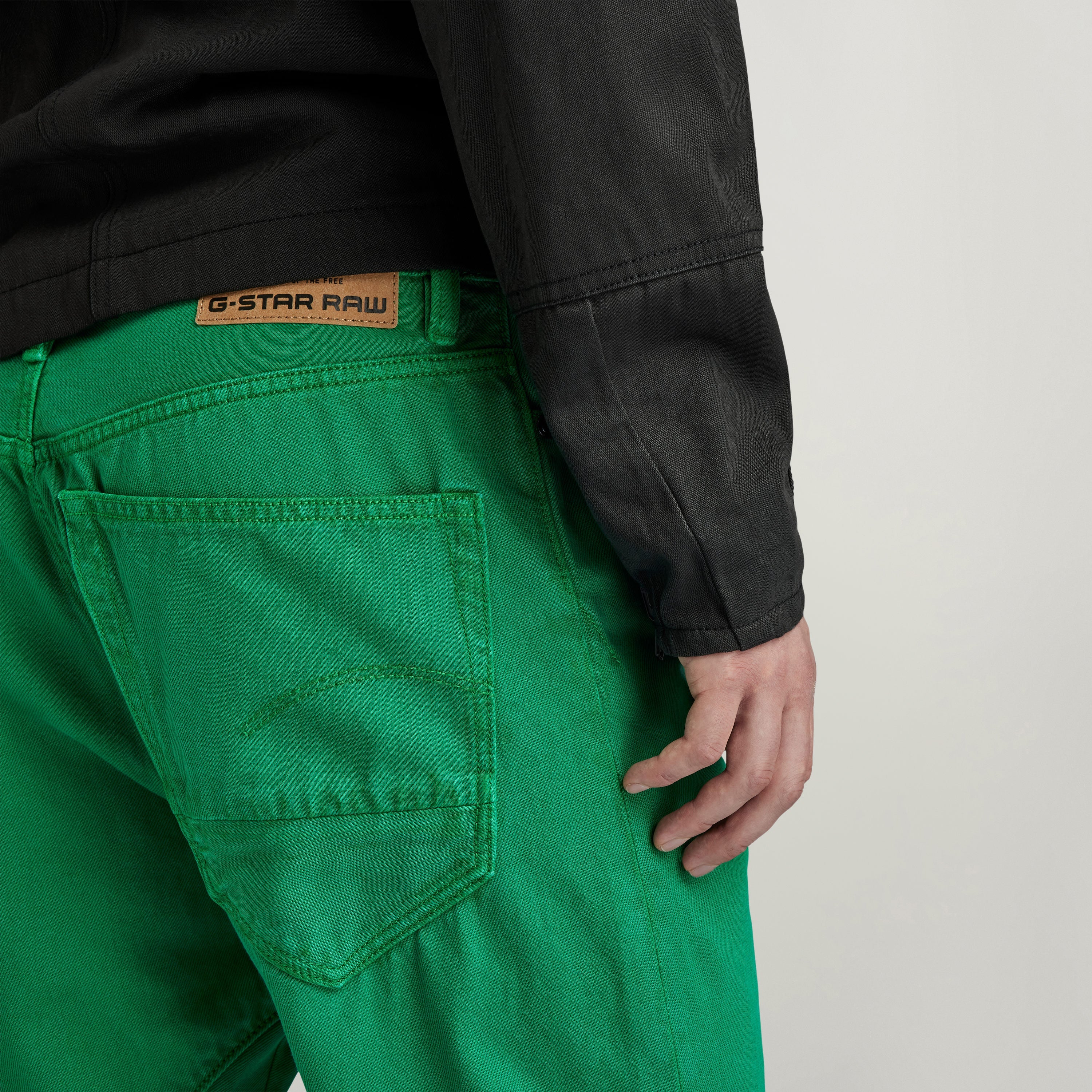 G-Star Arc 3D jeans in vibrant green with detailed stitching and iconic brand tag on the back.