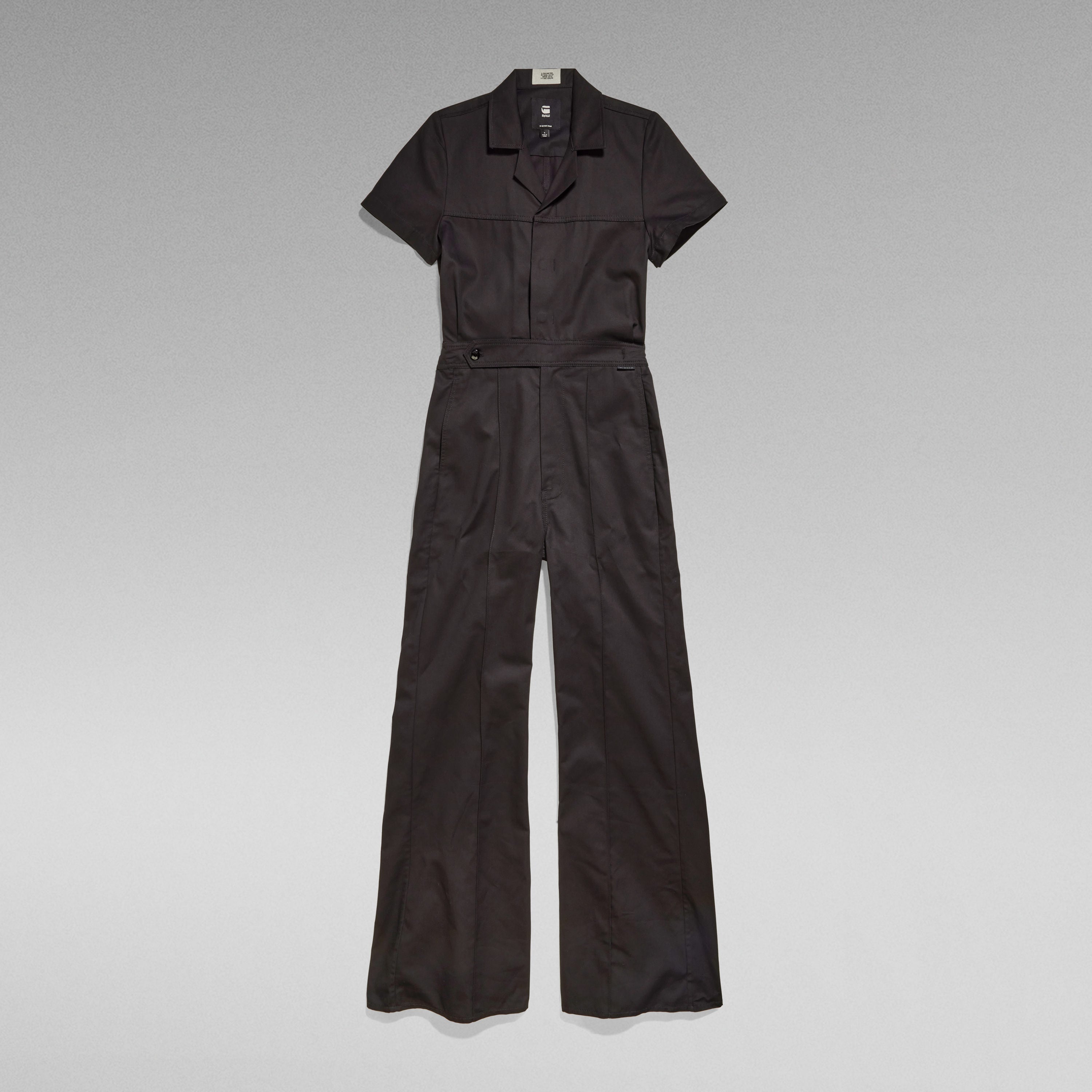 wide leg denim jumpsuit in black with short sleeves and relaxed fit, featuring 3D pockets and elastic waistband.