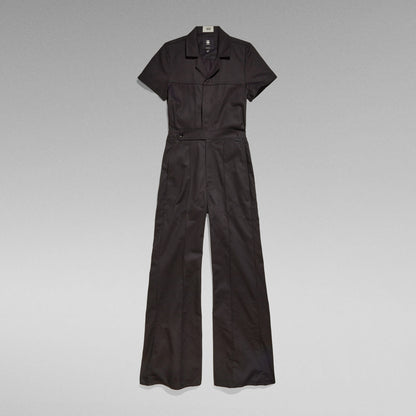 wide leg denim jumpsuit in black with short sleeves and relaxed fit, featuring 3D pockets and elastic waistband.